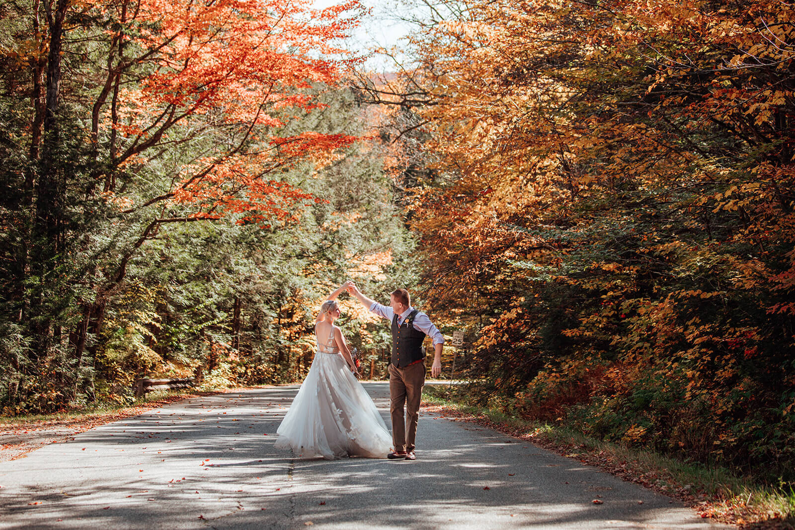  Couple dances through colorful tree tunnel after their elopement in Vermont 