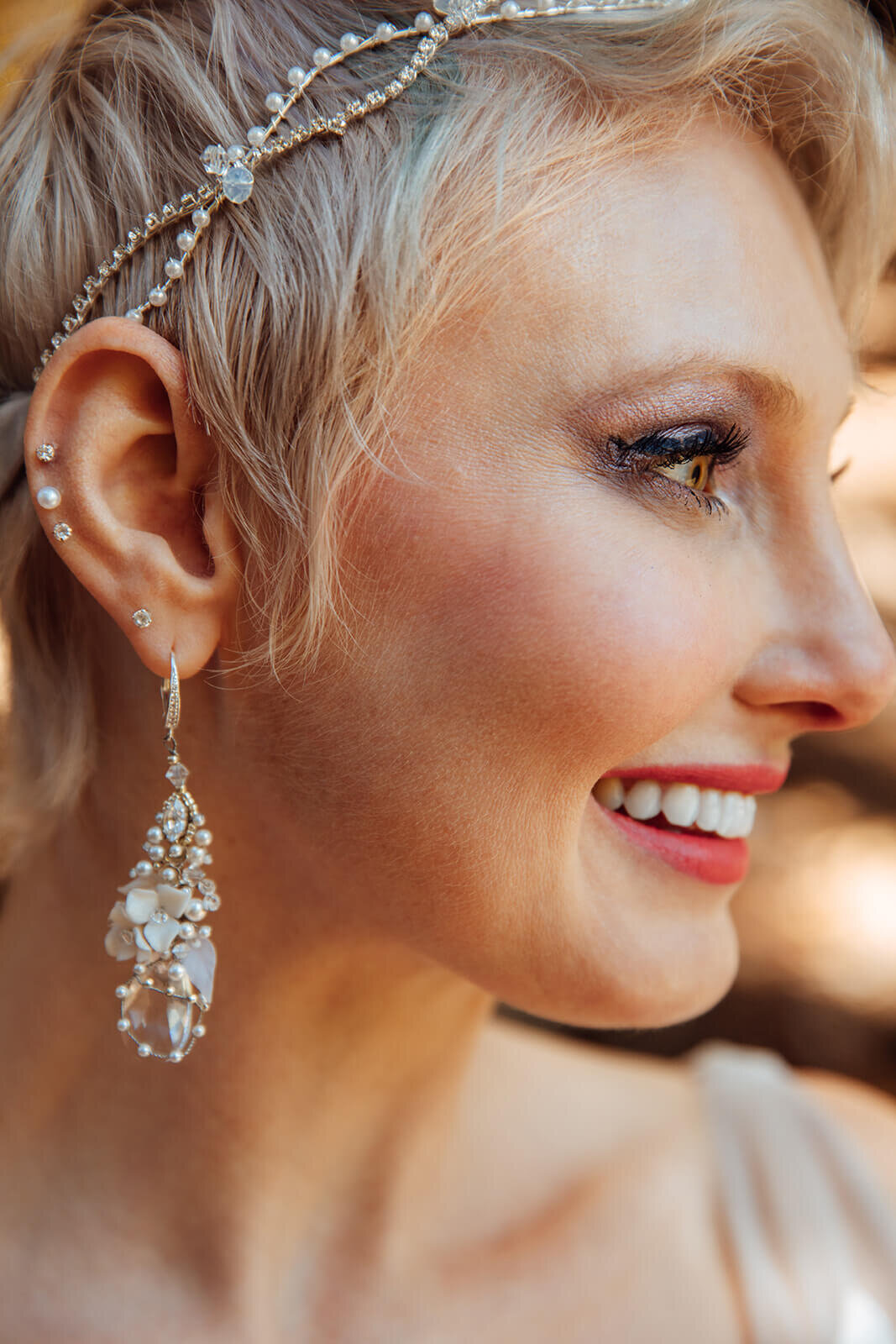  Bride smiles and shows off her jewelry during her fall elopement in Vermont 