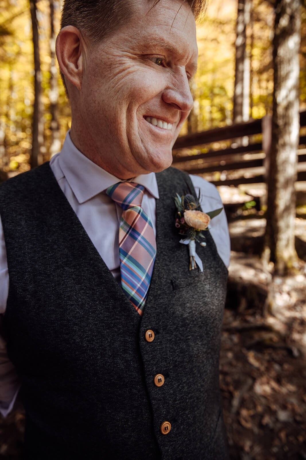  Groom smiles at his bride during his autumn elopement in Vermont 