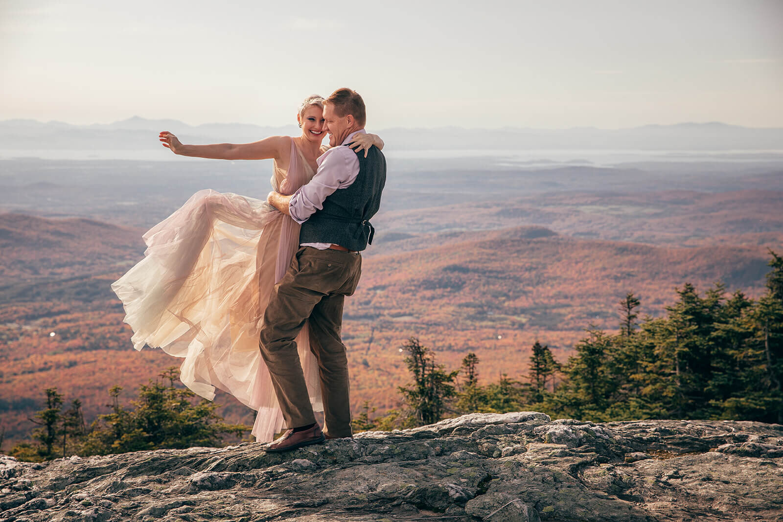  Eloping couple spinning around and celebrating on top of Mt. Mansfield in Stowe, Vermont 