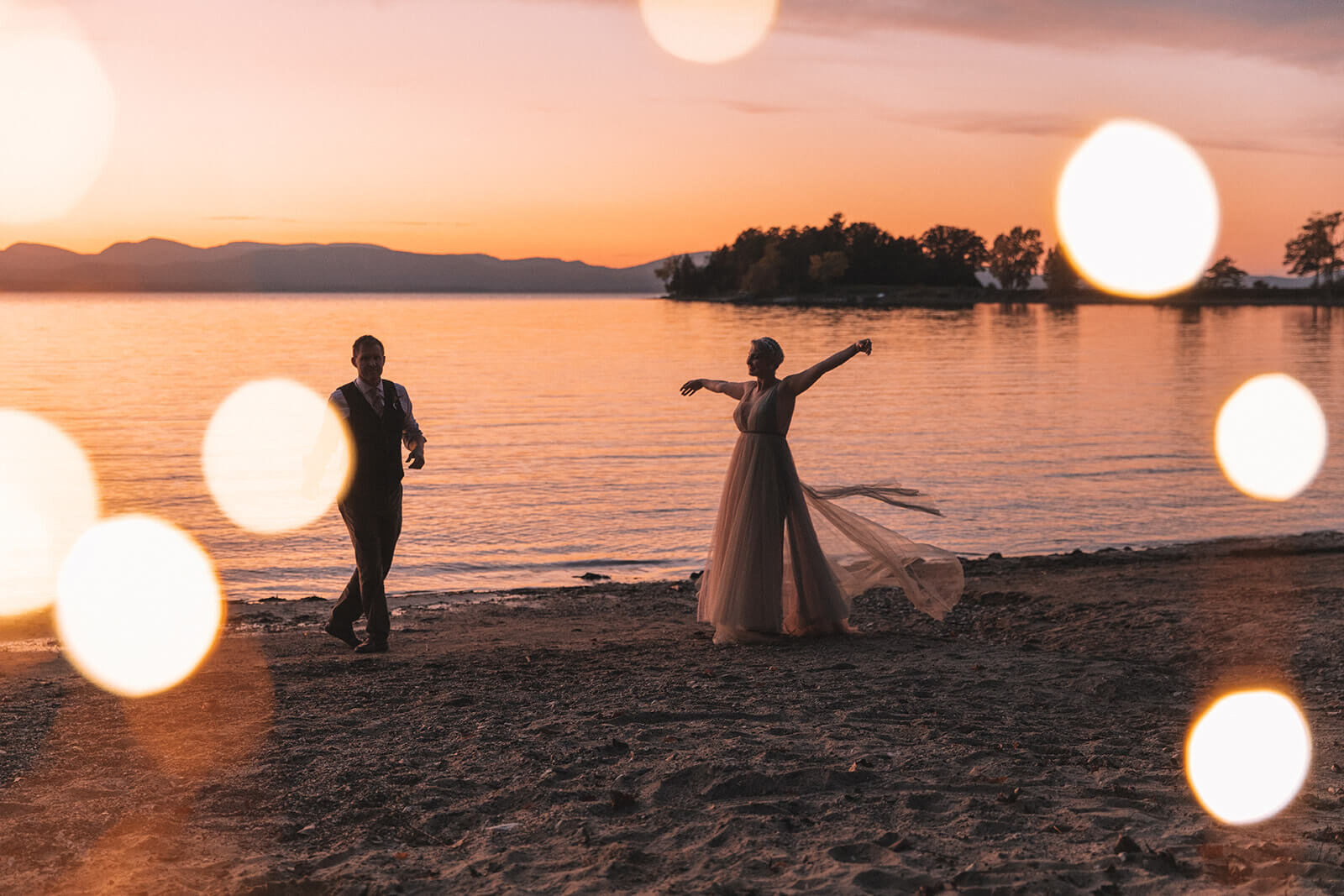  Bride and groom dance along Lake Champlain near Burlington, VT after their fall elopement 