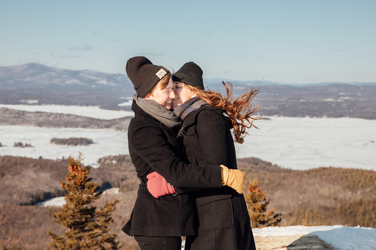  Couple cold on the summit of Mt. Major in New Hampshire in the winter for their anniversary. New Hampshire couples photographer 