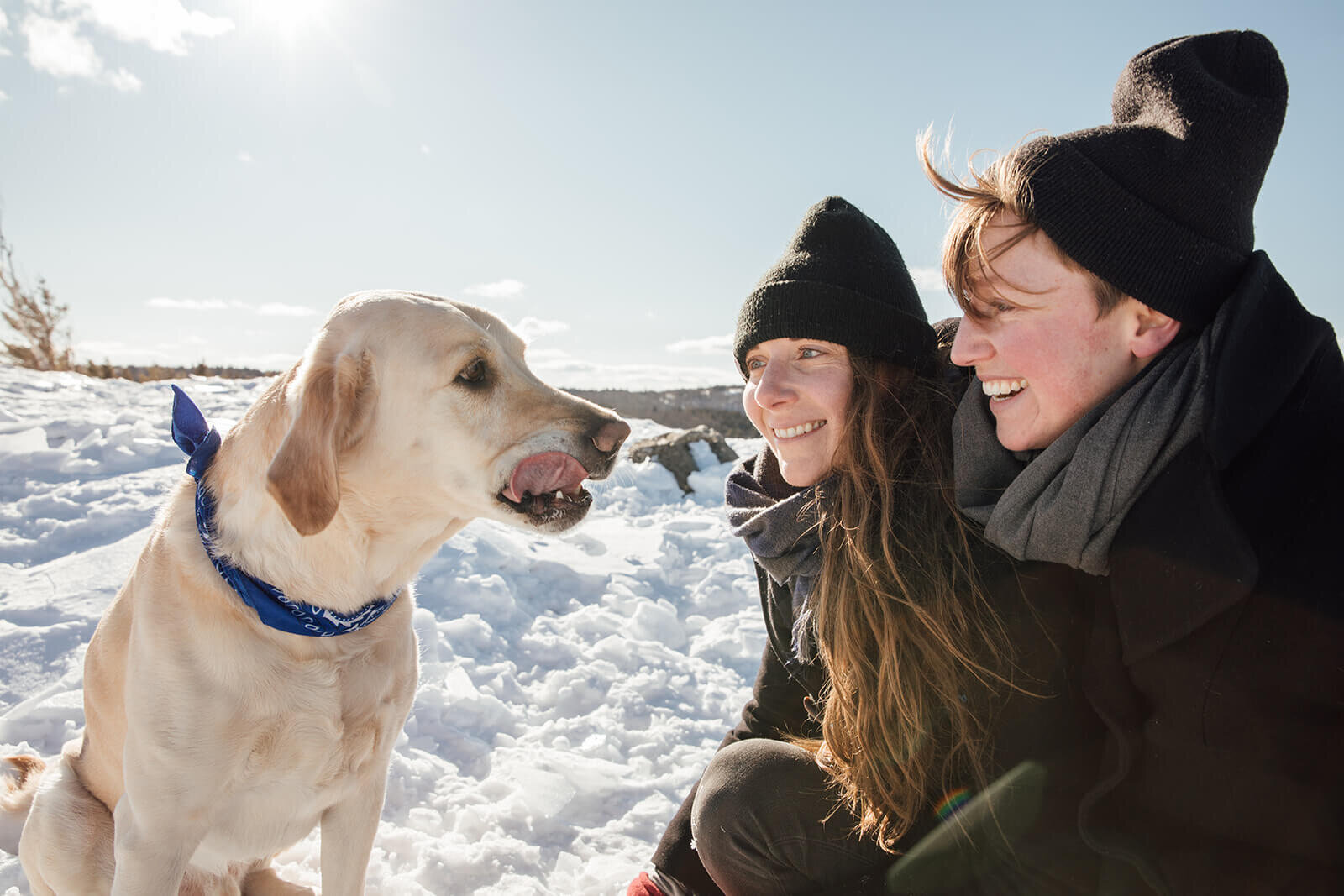  Couple cold on the summit of Mt. Major in New Hampshire in the winter with their dog. New Hampshire couples photographer 