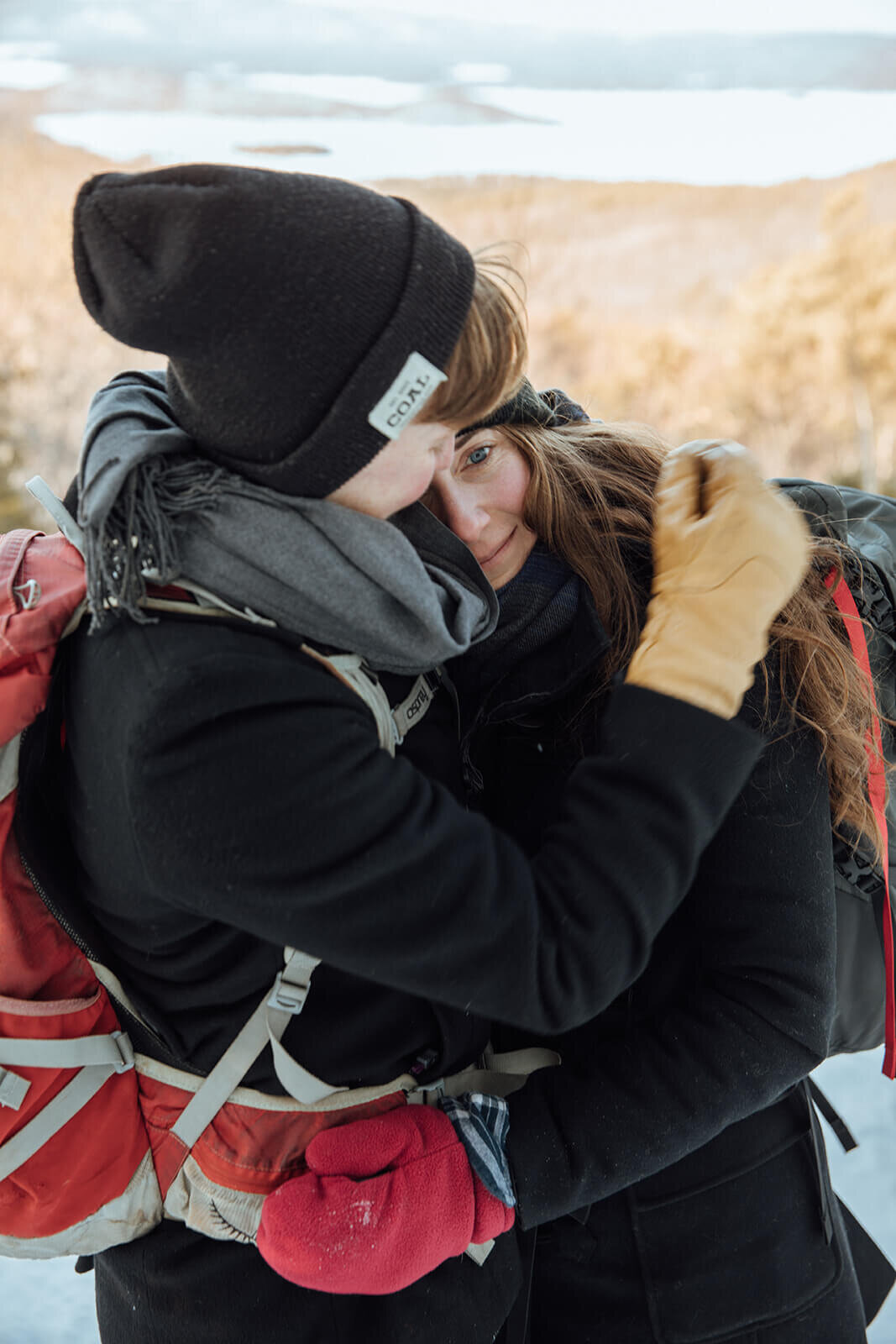   Couple cold on the summit of Mt. Major in New Hampshire in the winter for their anniversary. New Hampshire couples photographer  