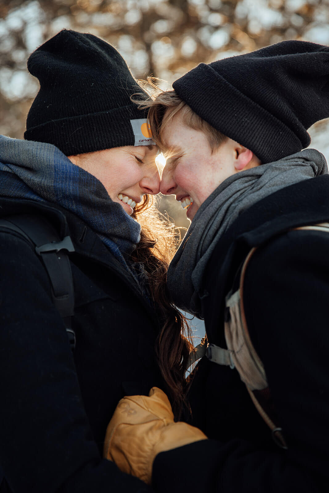  Couple laughs as sunsets on Mt. Major in New Hampshire in the winter for their anniversary. New Hampshire elopement photographer 