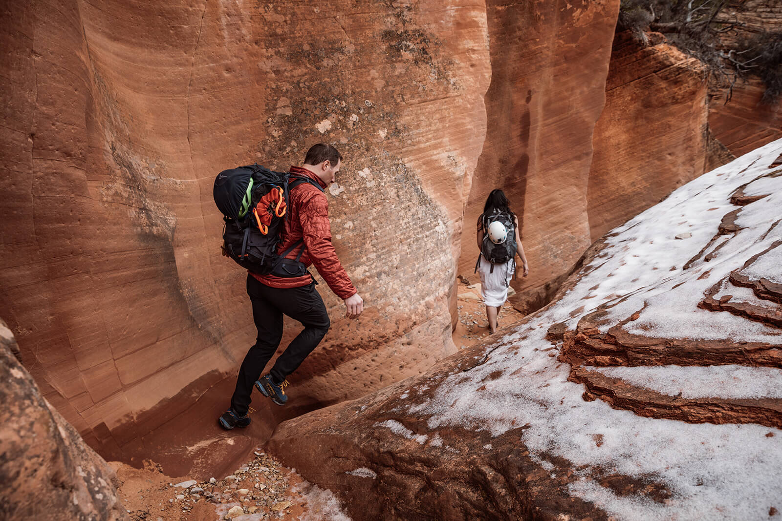  Eloping couple explore canyon with snow on the ground outside of Zion National Park. Zion National Park elopement photographer 