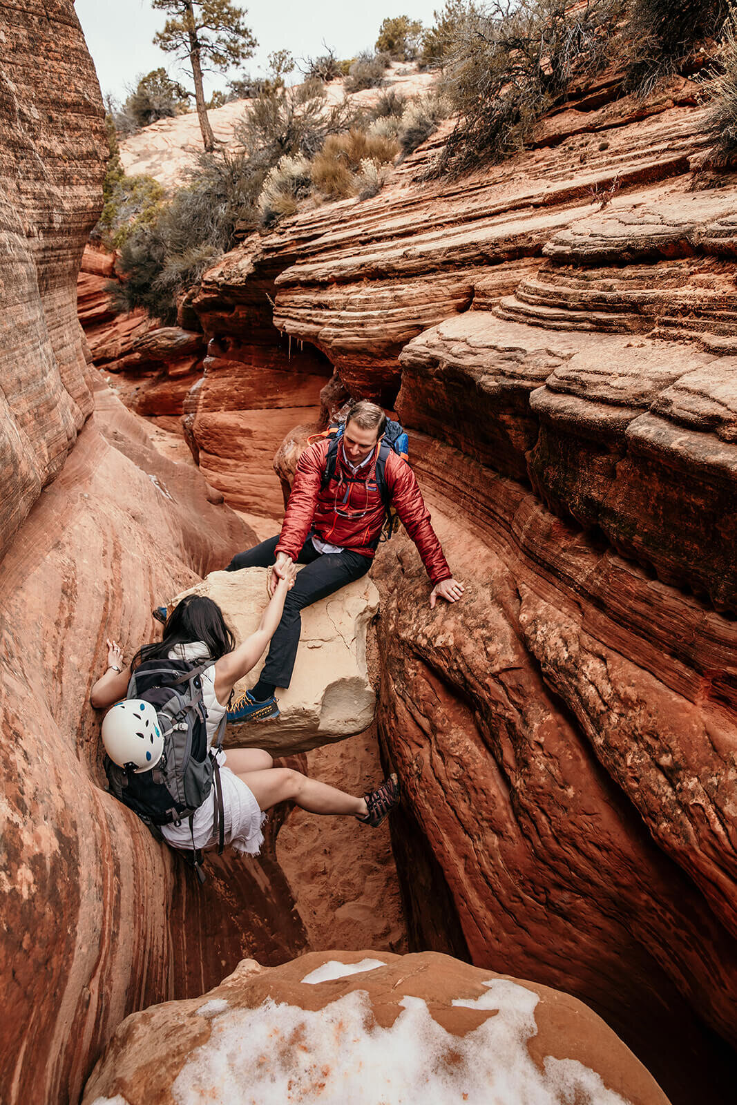  Eloping couple explore and downclimb in a technical canyon outside of Zion National Park. Zion National Park elopement photographer 