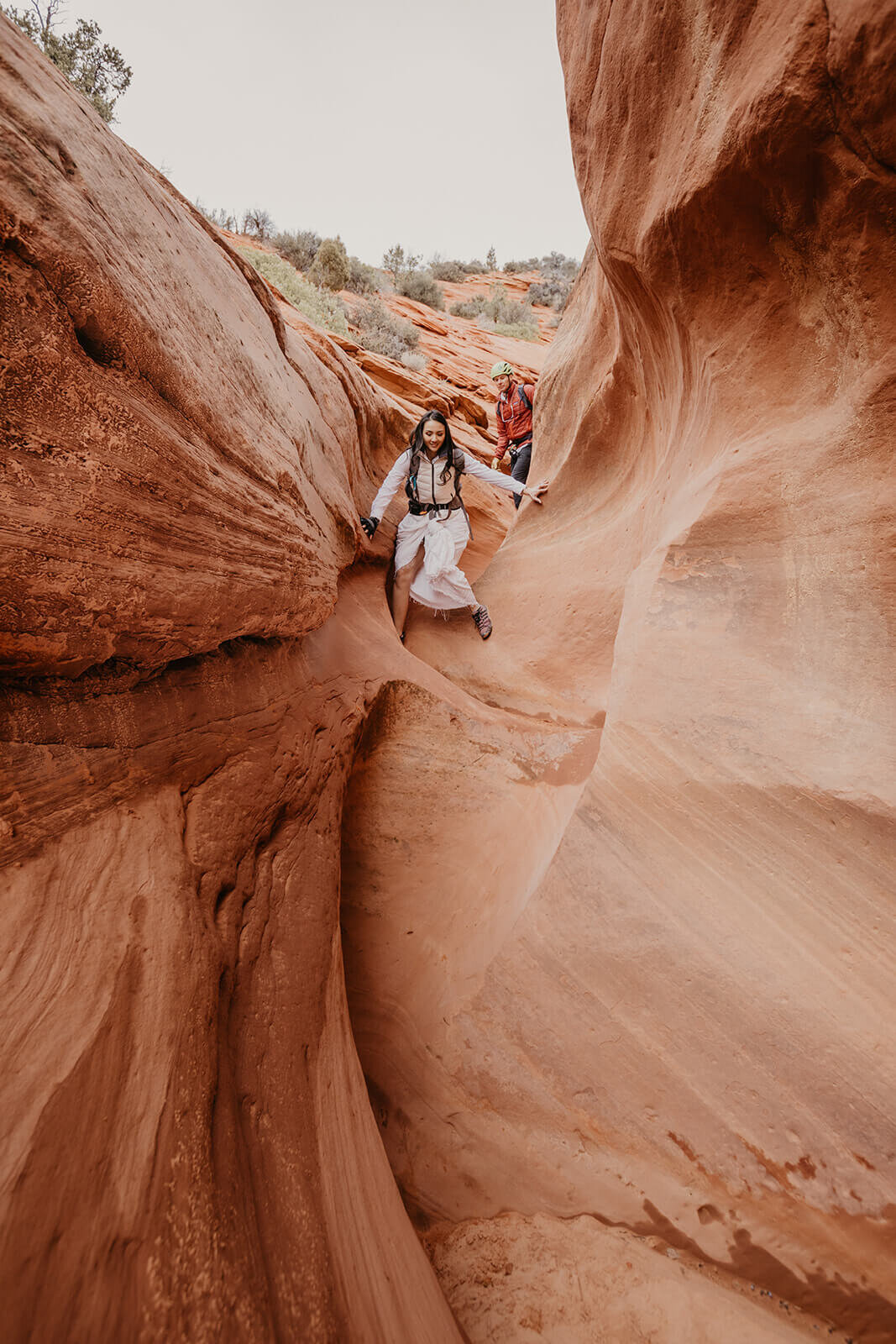  Eloping couple explore and downclimb in a technical canyon outside of Zion National Park. Zion National Park elopement photographer 