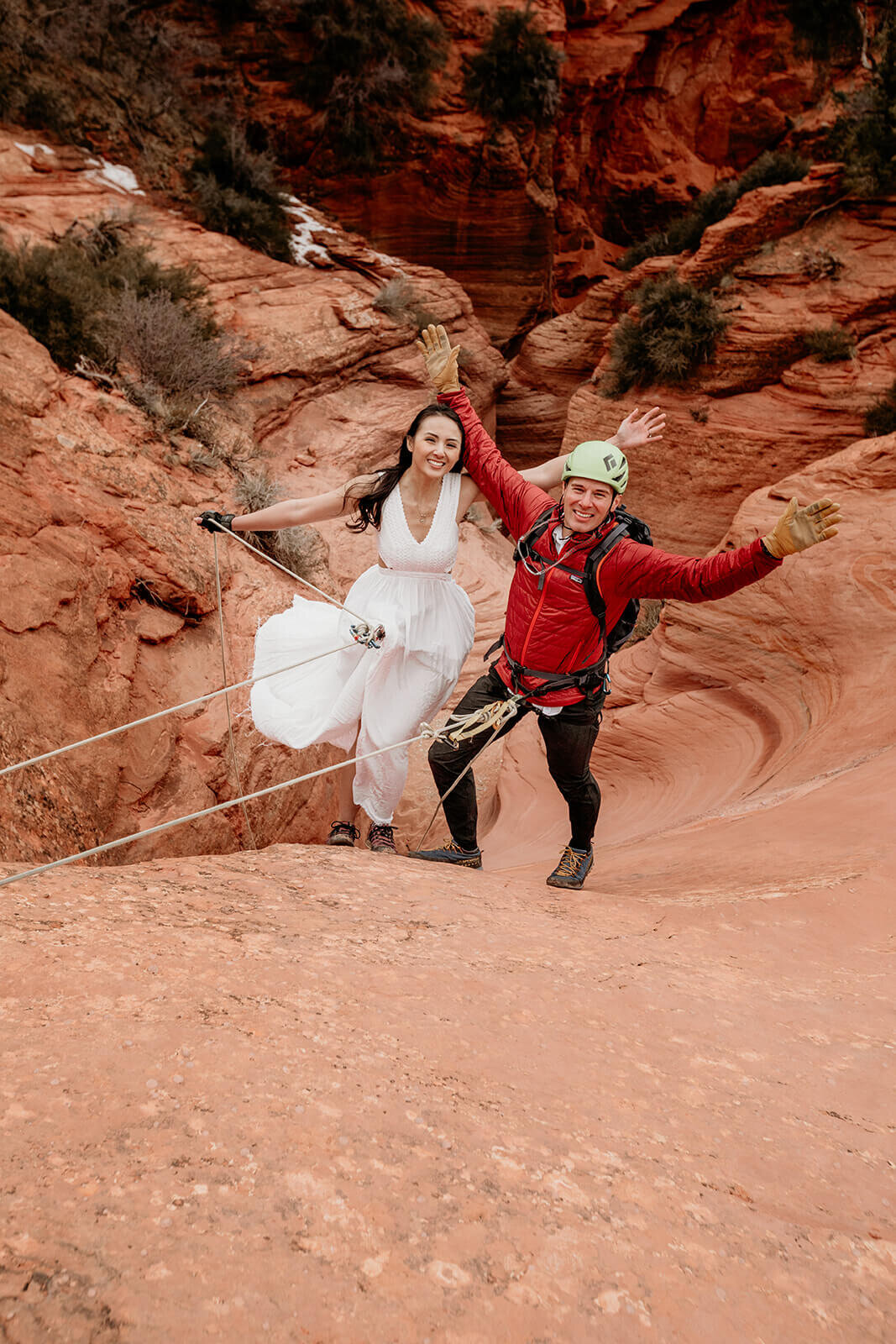  Man proposes to woman on rappel in a technical canyon outside of Zion National Park. Zion National Park elopement photographer 