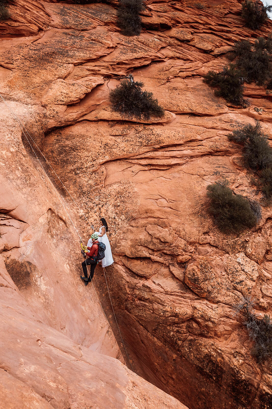  Man proposes to woman on rappel in a technical canyon outside of Zion National Park. Zion National Park elopement photographer 