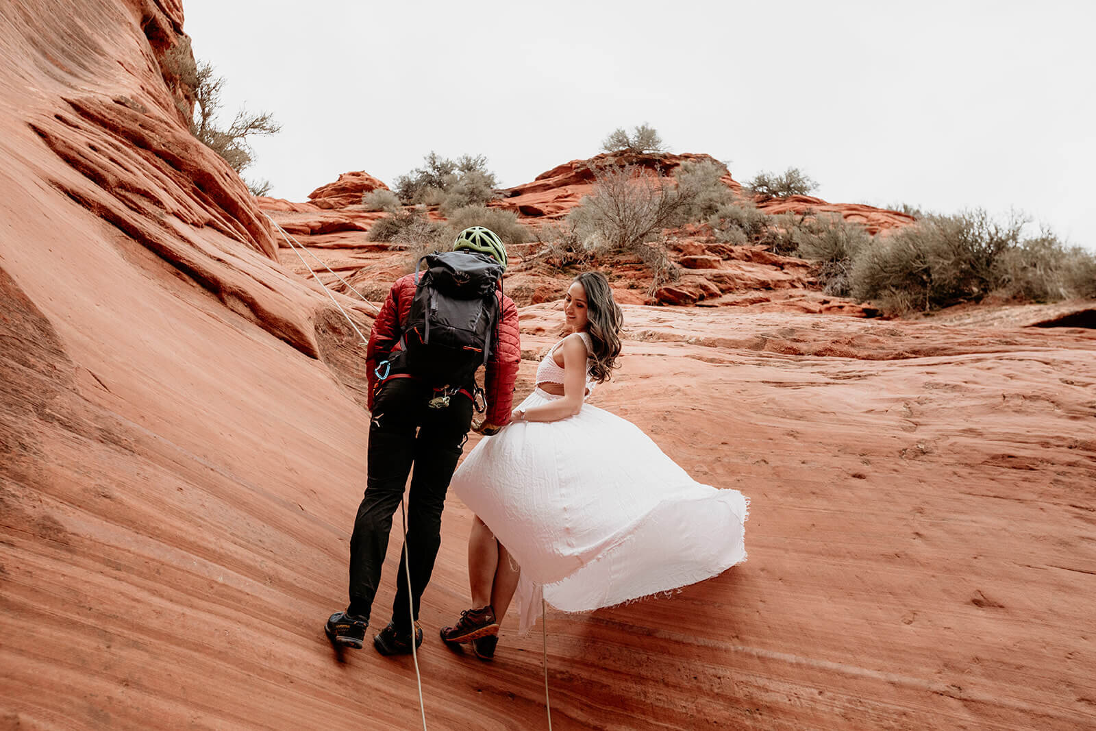  Man proposes to woman on rappel in a technical canyon outside of Zion National Park. Zion National Park elopement photographer 