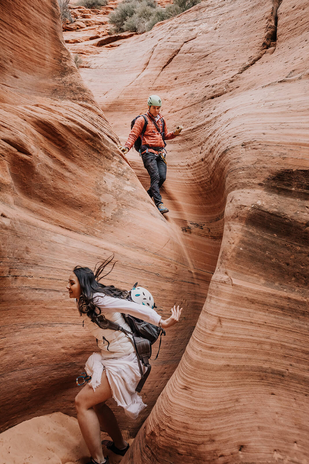  Eloping couple explore and downclimb in a technical canyon outside of Zion National Park. Zion National Park elopement photographer 