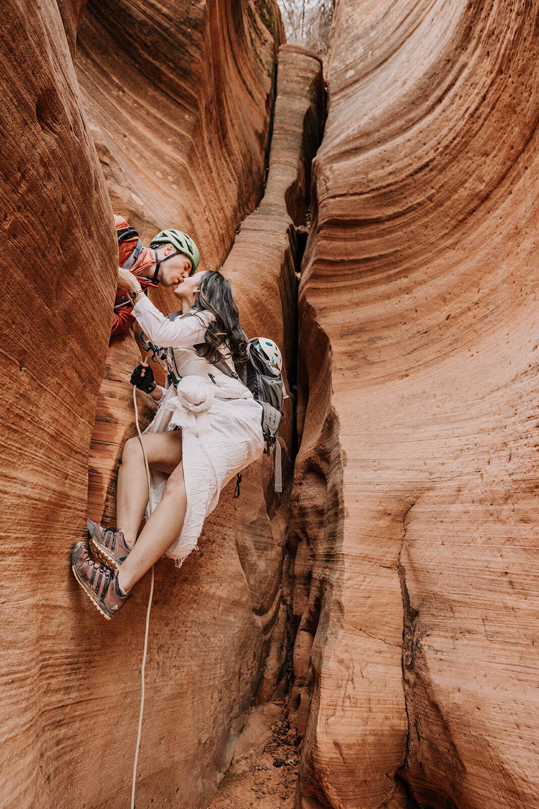  Eloping couple explore and rappel in a technical canyon outside of Zion National Park. Zion National Park elopement photographer 