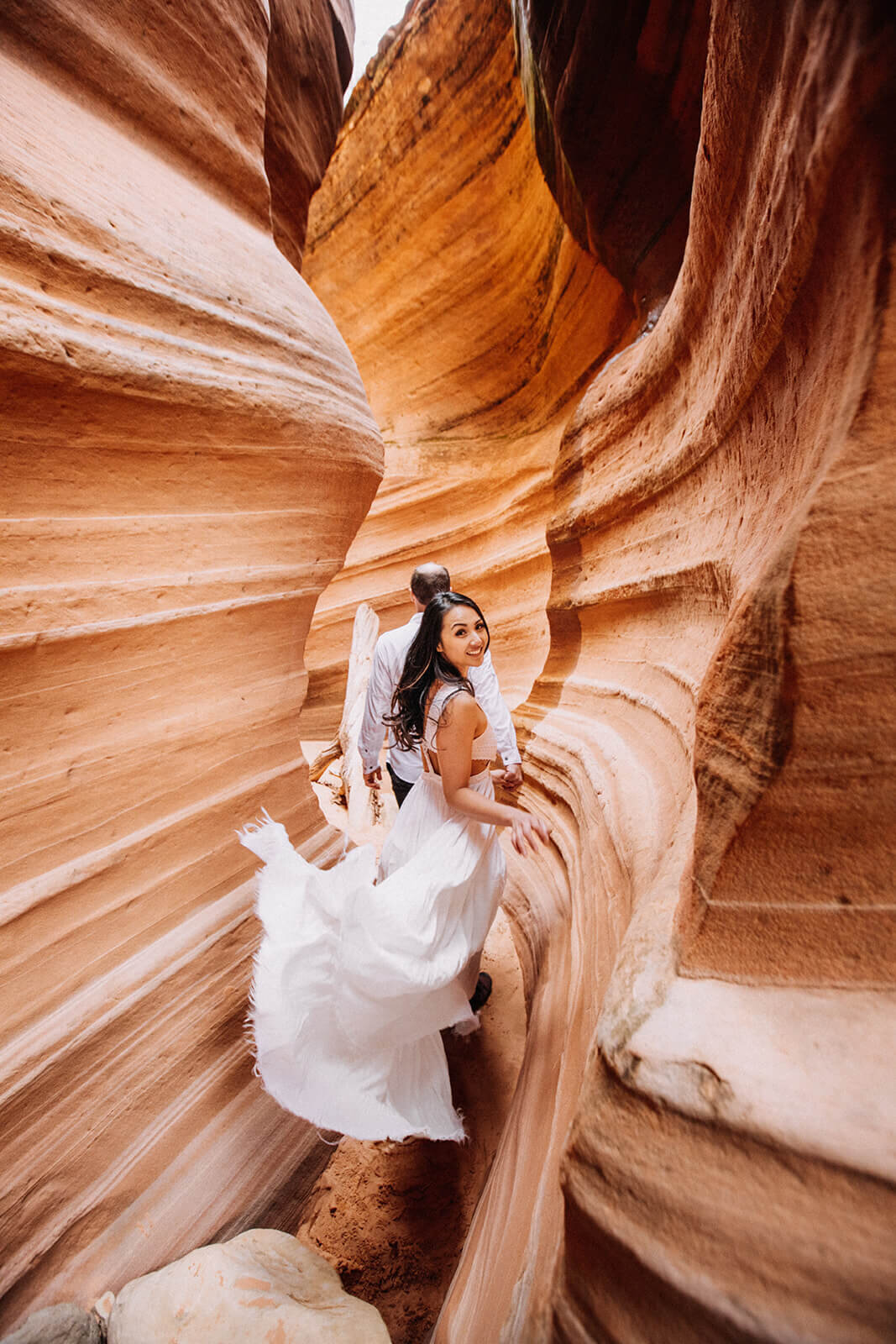  Eloping couple explore a technical canyon outside of Zion National Park. Zion National Park elopement photographer 