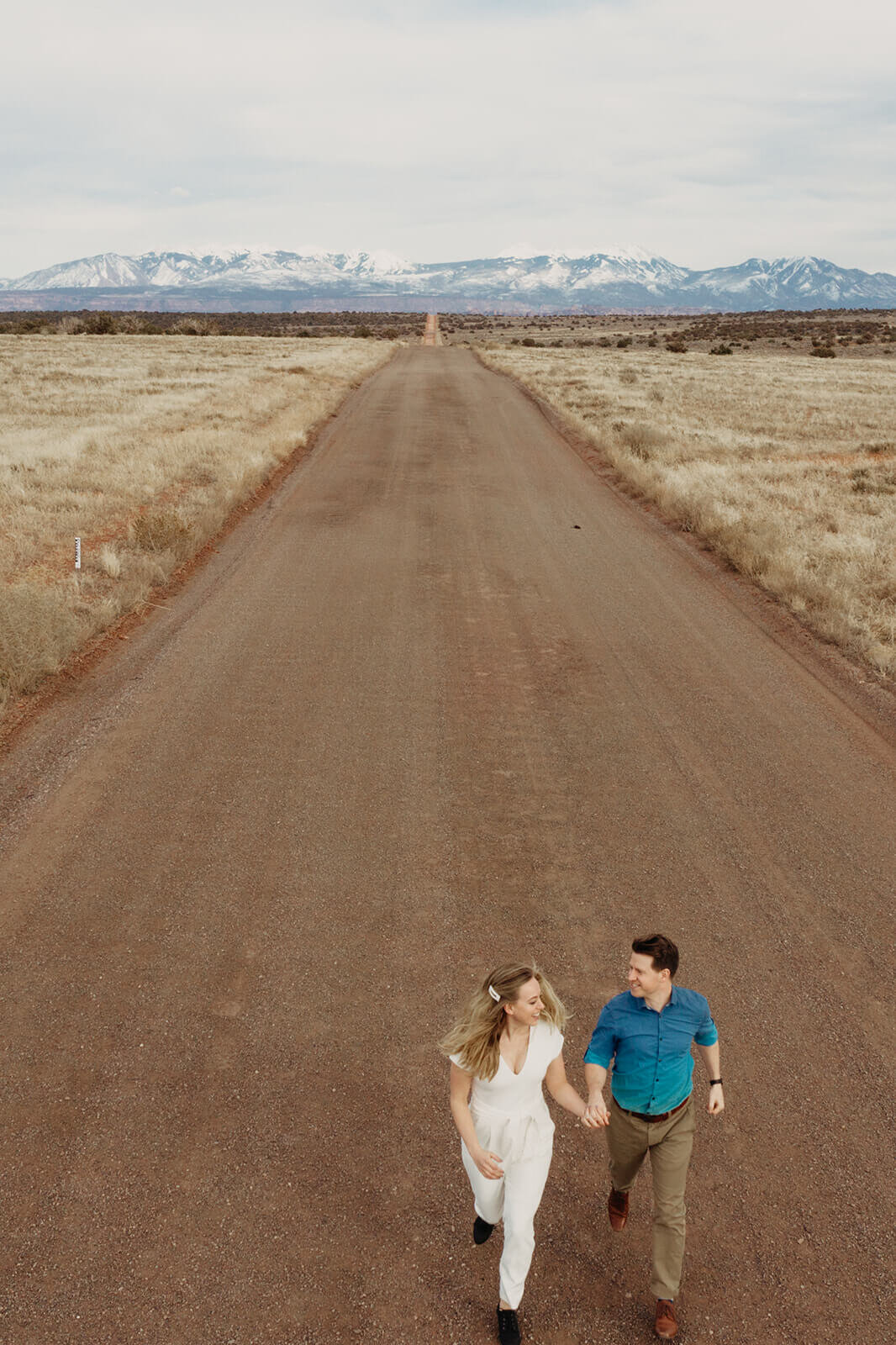  Couple celebrates anniversary at Dead Horse Point State Park and the La Sal Mountains near Moab, Utah with incredible views and hiking. Utah wedding photographer 