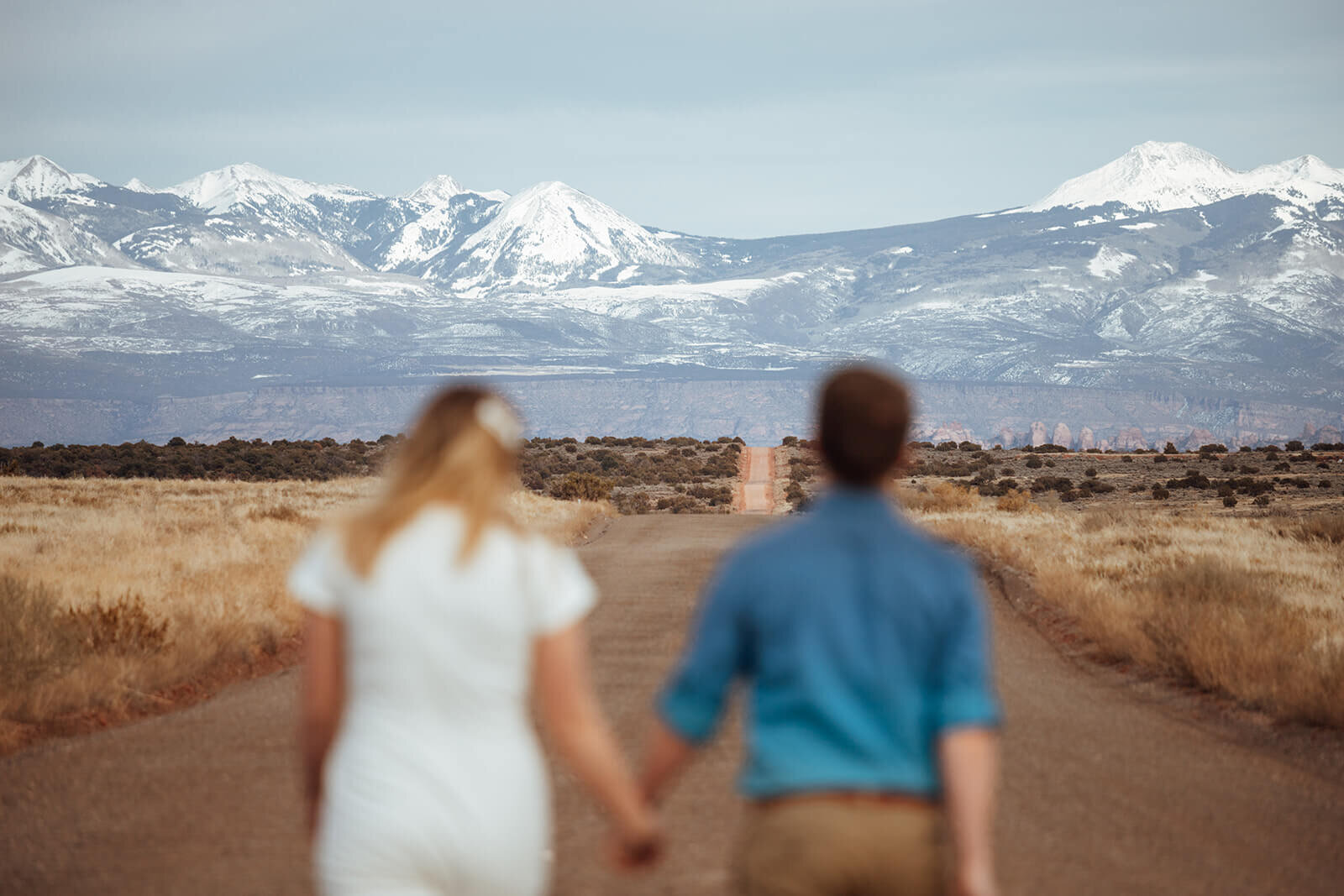  Couple celebrates anniversary at Dead Horse Point State Park and the La Sal Mountains near Moab, Utah with incredible views and hiking. Utah engagement photographer 