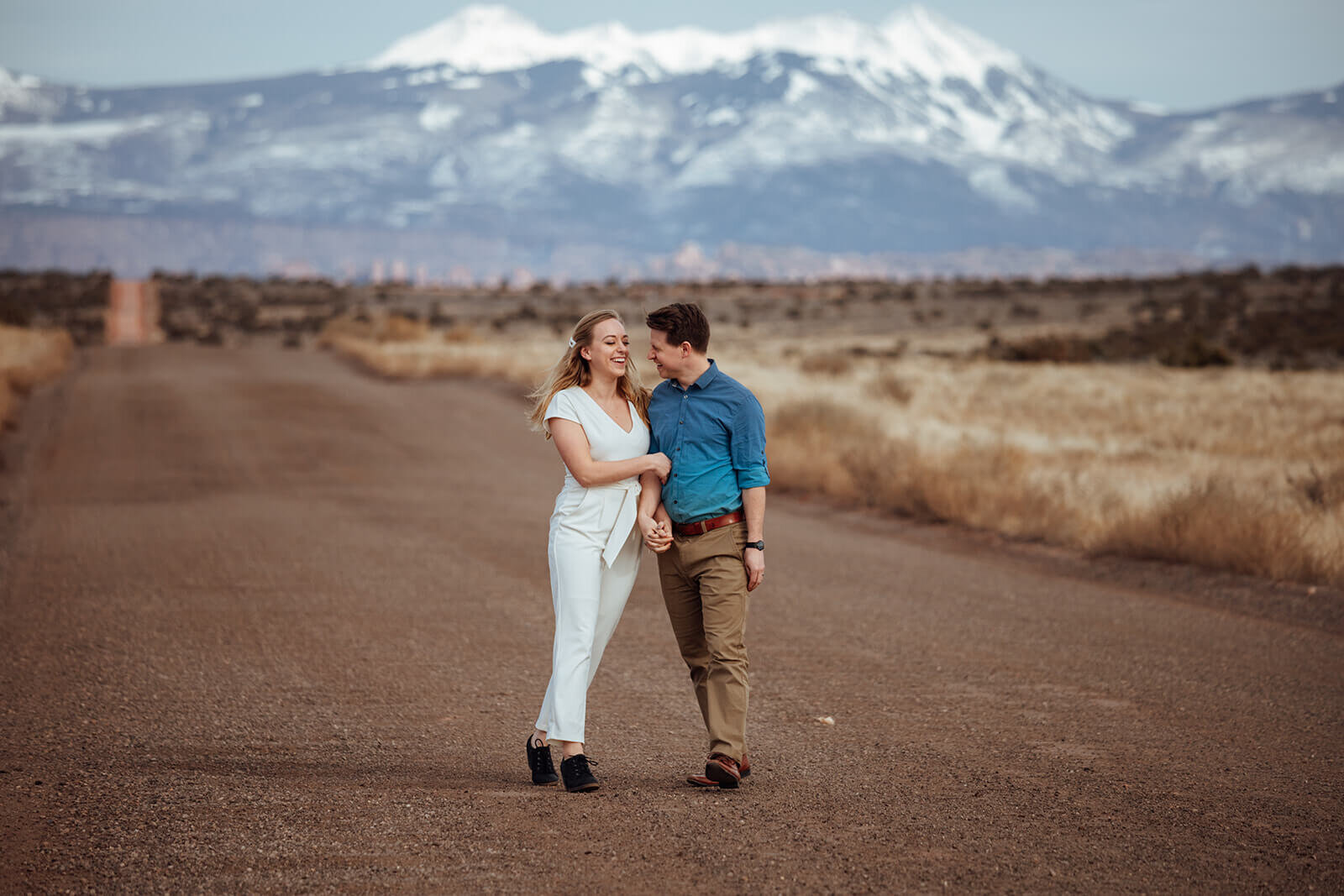  Couple celebrates anniversary at Dead Horse Point State Park and the La Sal Mountains near Moab, Utah with incredible views and hiking. Utah elopement photographer 