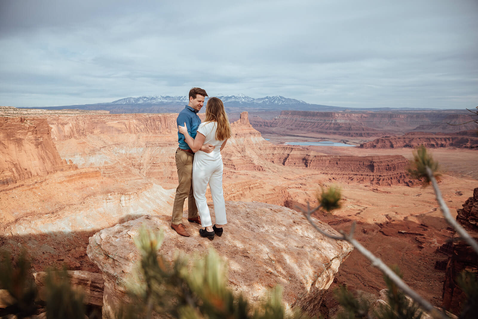  Couple celebrates anniversary at Dead Horse Point State Park and the La Sal Mountains near Moab, Utah with incredible views and hiking. Utah couples photographer 