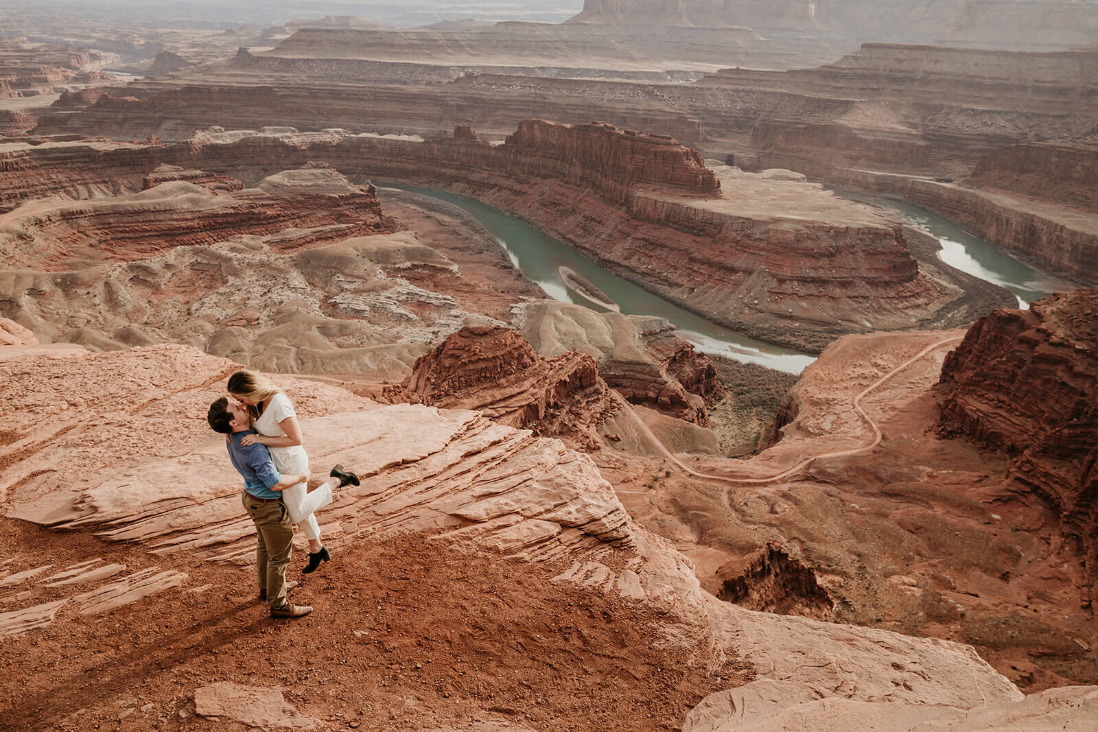  Couple celebrates anniversary at Dead Horse Point State Park and the La Sal Mountains near Moab, Utah with incredible views and hiking. Utah elopement photographer 