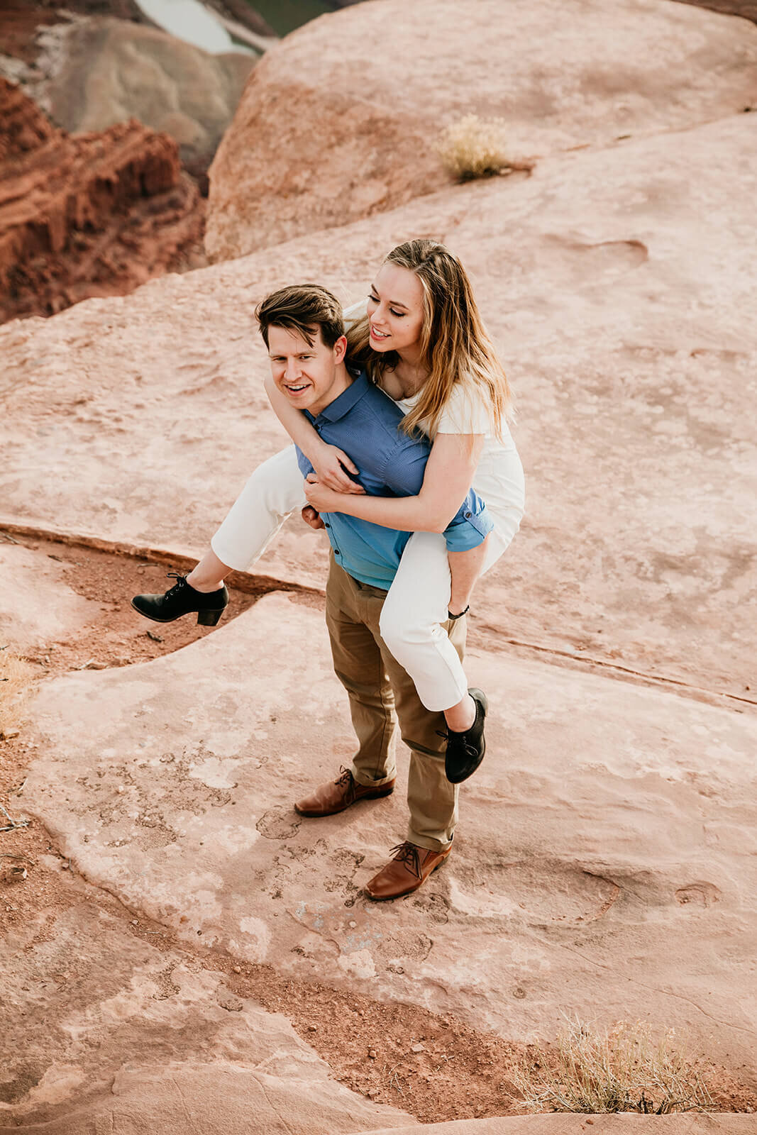  Couple celebrates anniversary at Dead Horse Point State Park and the La Sal Mountains near Moab, Utah with incredible views and hiking. Utah elopement photographer 