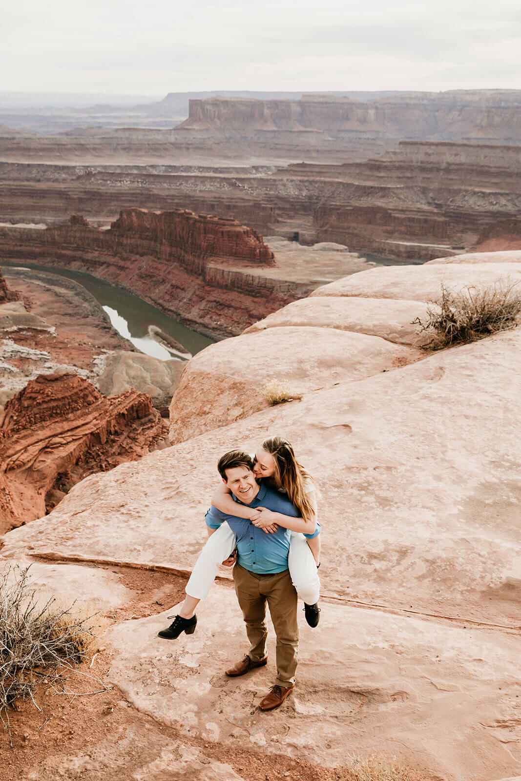  Couple celebrates anniversary at Dead Horse Point State Park and the La Sal Mountains near Moab, Utah with incredible views and hiking. Utah outdoor wedding photographer 