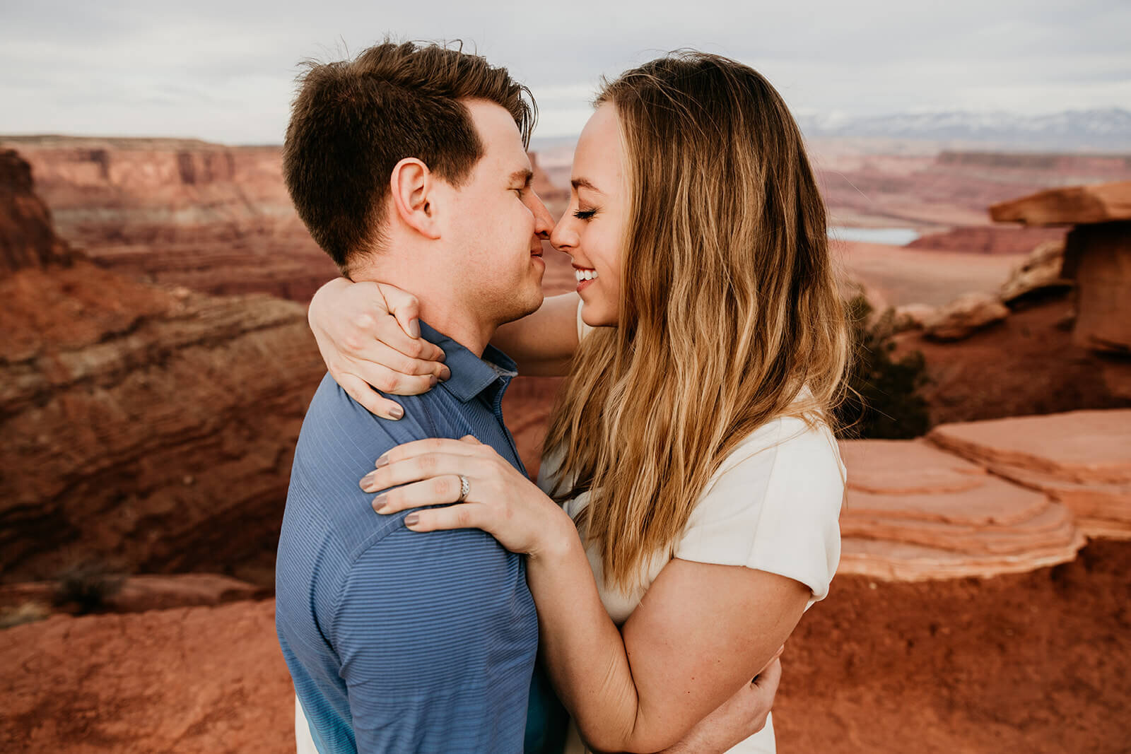  Couple celebrates anniversary at Dead Horse Point State Park and the La Sal Mountains near Moab, Utah with incredible views and hiking. Utah elopement photographer 