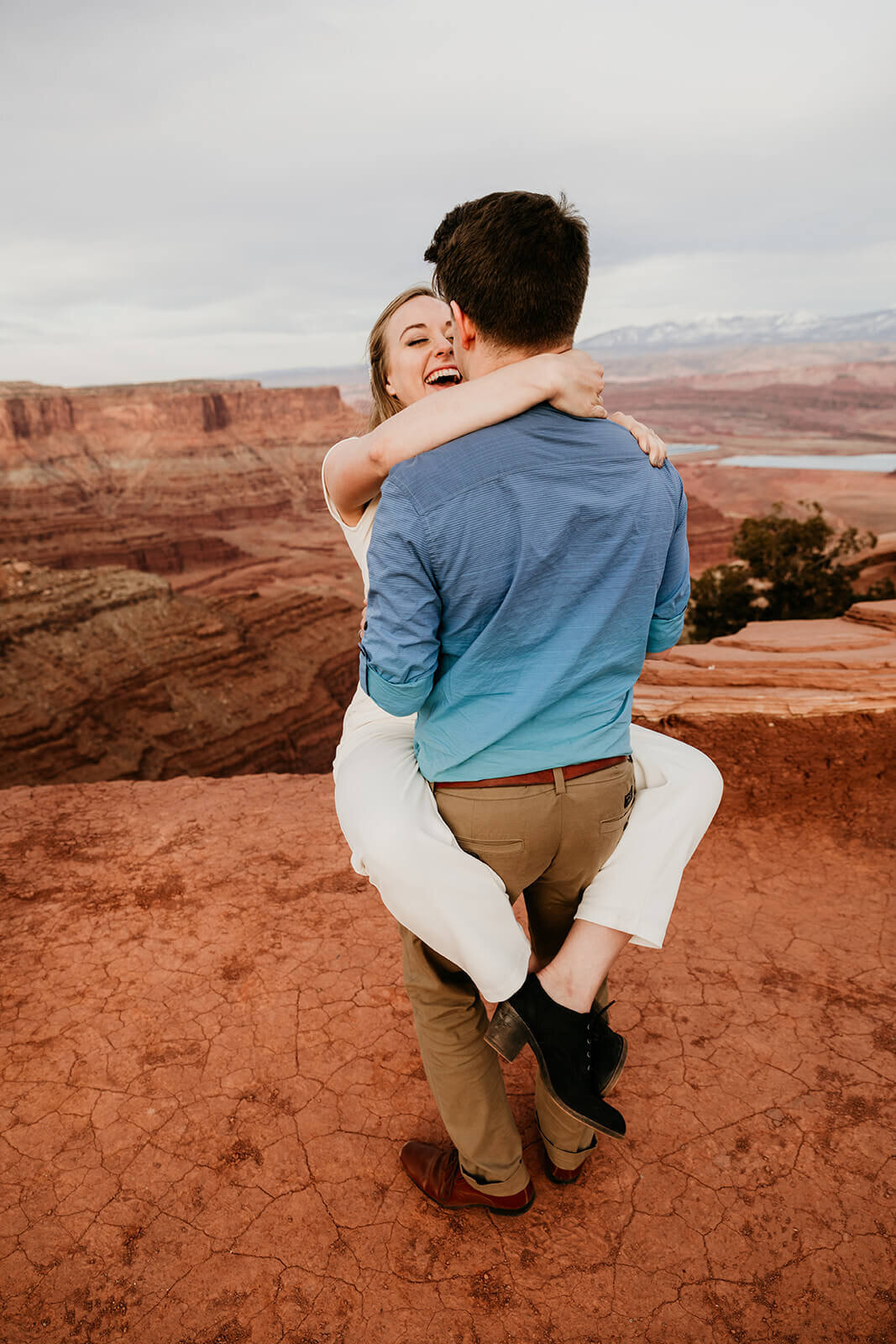  Couple celebrates anniversary at Dead Horse Point State Park and the La Sal Mountains near Moab, Utah with incredible views and hiking. Utah elopement photographer 