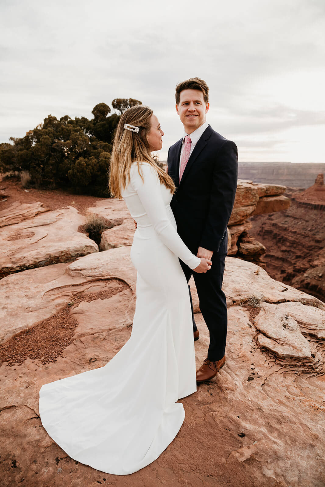  Couple celebrates anniversary at Dead Horse Point State Park and the La Sal Mountains near Moab, Utah with incredible views and hiking. Utah elopement photographer 