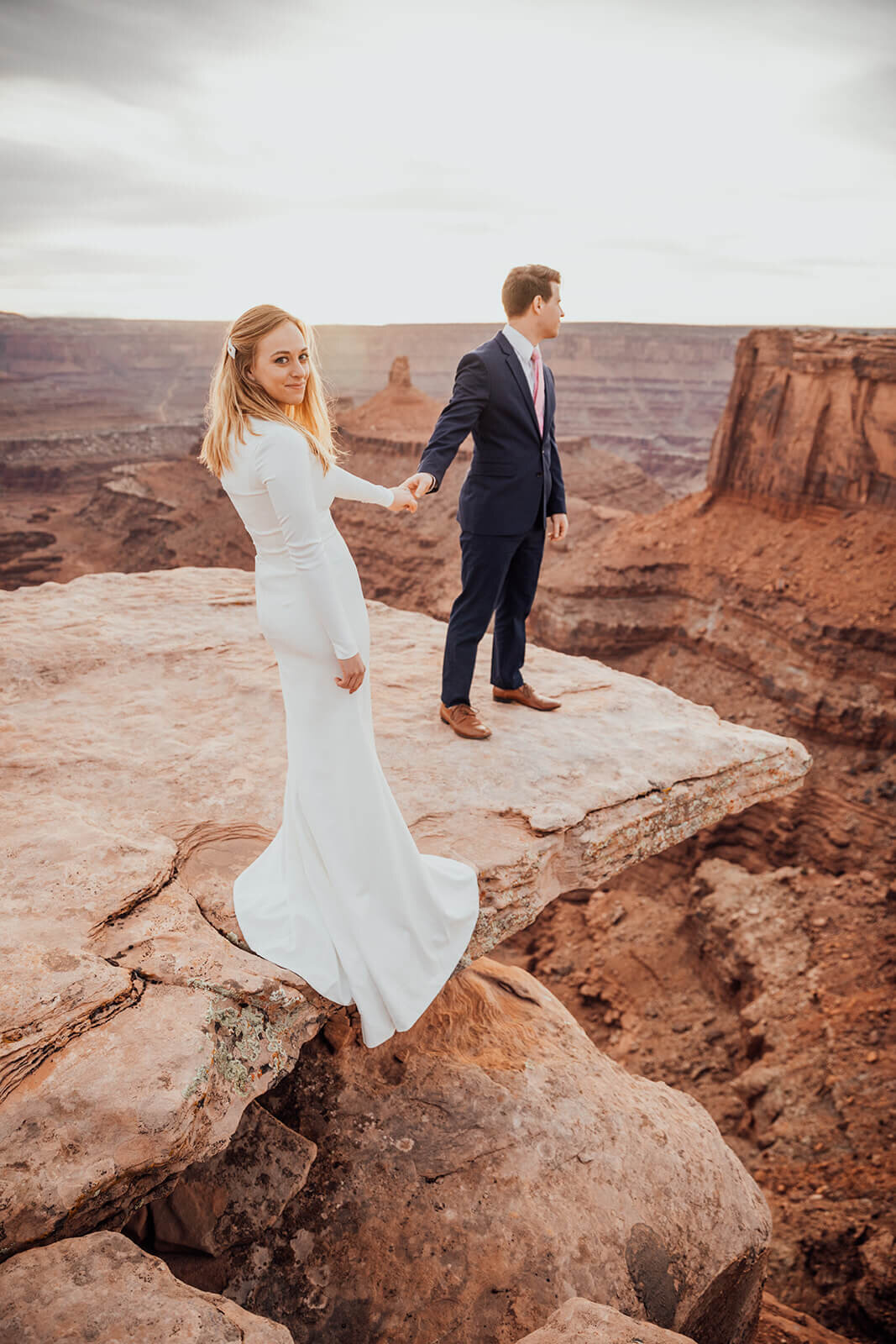  Couple celebrates anniversary at Dead Horse Point State Park and the La Sal Mountains near Moab, Utah with incredible views and hiking. Utah elopement photographer 