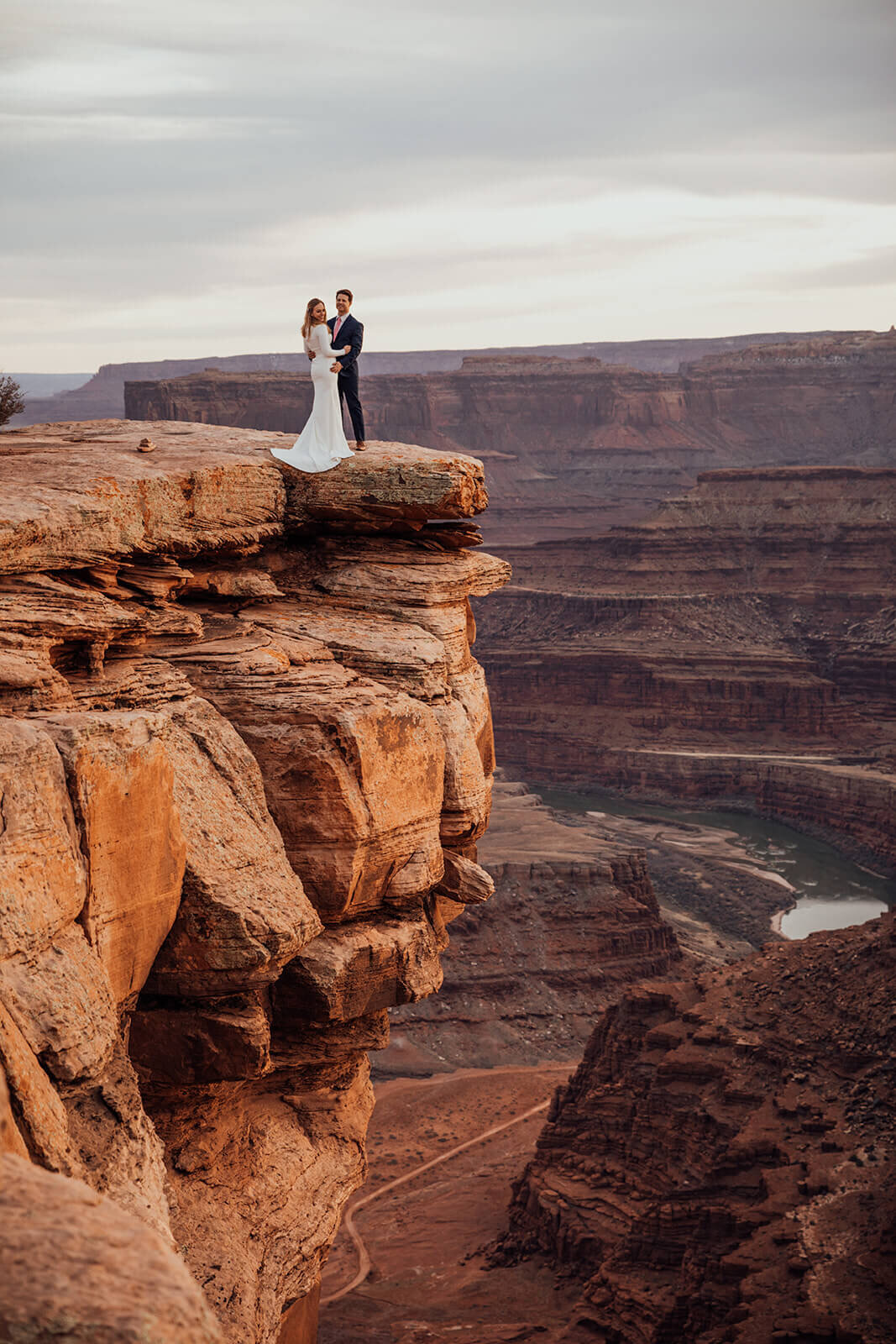  Couple celebrates anniversary at Dead Horse Point State Park and the La Sal Mountains near Moab, Utah with incredible views and hiking. Utah elopement photographer 