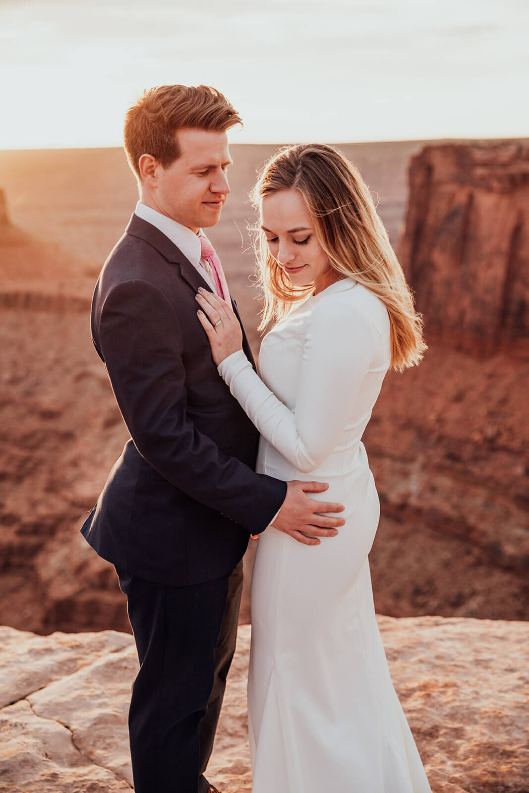  Couple celebrates anniversary at Dead Horse Point State Park and the La Sal Mountains near Moab, Utah with incredible views and hiking. Utah elopement photographer 