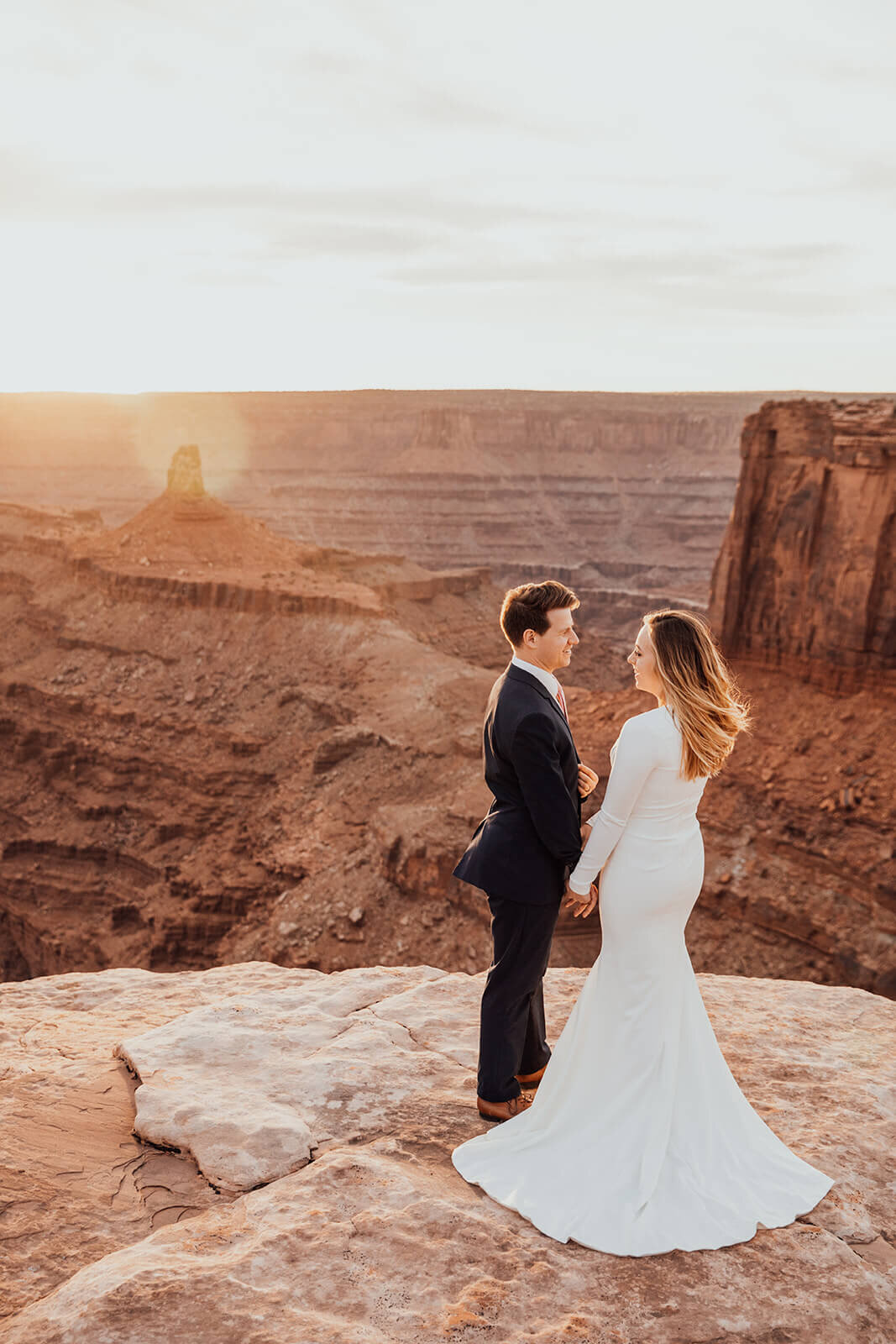  Couple celebrates anniversary at Dead Horse Point State Park and the La Sal Mountains near Moab, Utah with incredible views and hiking. Utah elopement photographer 