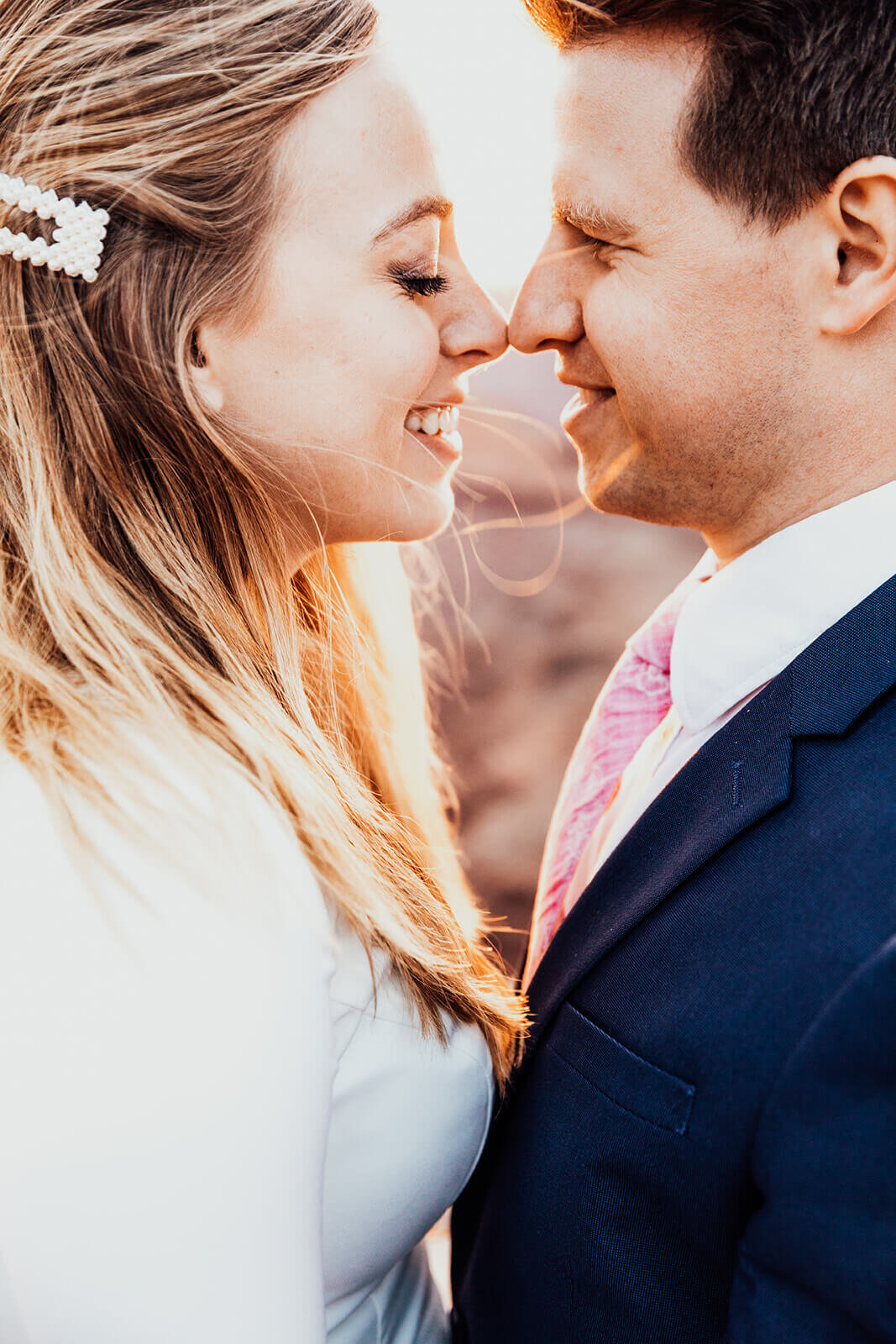  Couple kiss during anniversary celebration at sunset at Dead Horse Point State Park and the La Sal Mountains near Moab, Utah with incredible views and hiking. Utah wedding photographer 