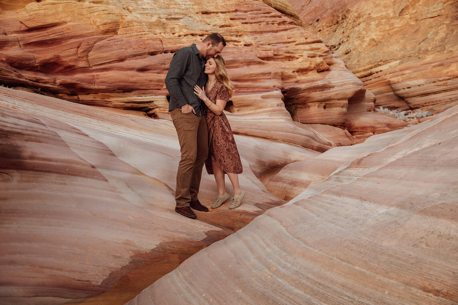  Couple explores a canyon in Valley of Fire State Park next to Lake Mead, outside of Las Vegas, Nevada. Desert southwest elopement photographer 