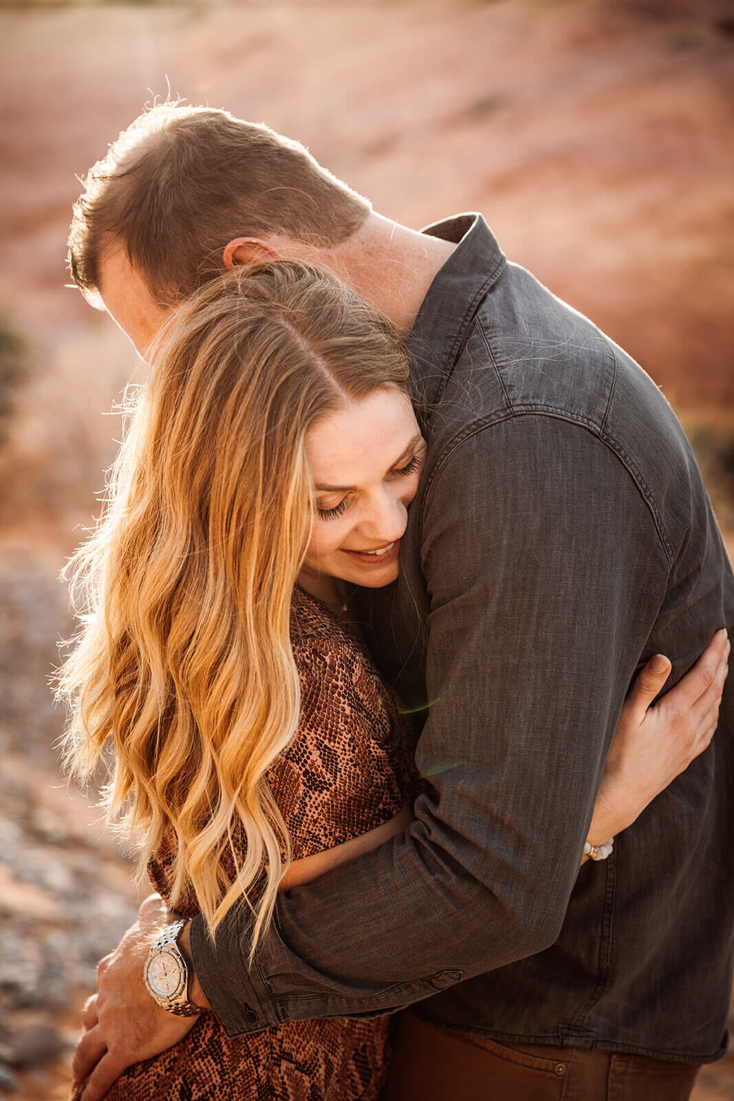 Couple walk through canyon in Valley of Fire State Park next to Lake Mead, outside of Las Vegas, Nevada. Nevada engagement photographer 