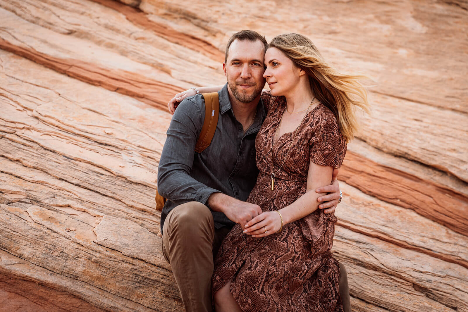  Couple hikes through canyon in Valley of Fire State Park next to Lake Mead, outside of Las Vegas, Nevada. Las Vegas engagement photographer 