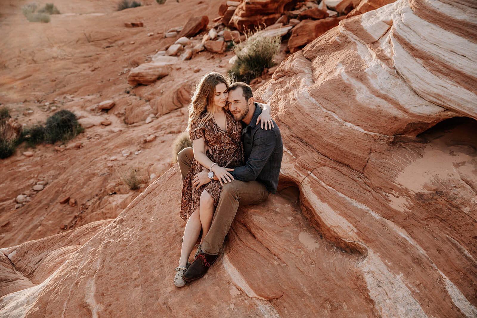  Couple hikes to the Fire Wave in Valley of Fire State Park next to Lake Mead, outside of Las Vegas, Nevada. Las Vegas engagement photographer 