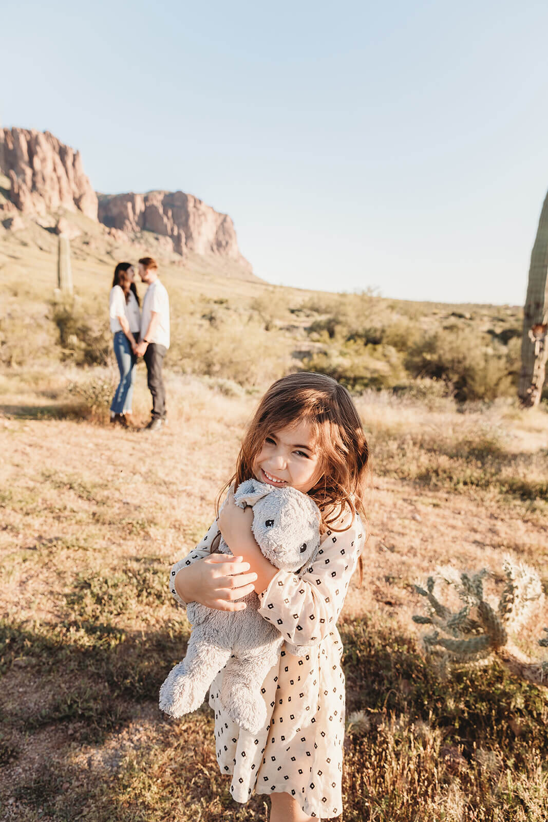  Couple includes their daughter in engagement session in the Superstition Mountains outside of Phoenix, Arizona. Arizona elopement photographer 