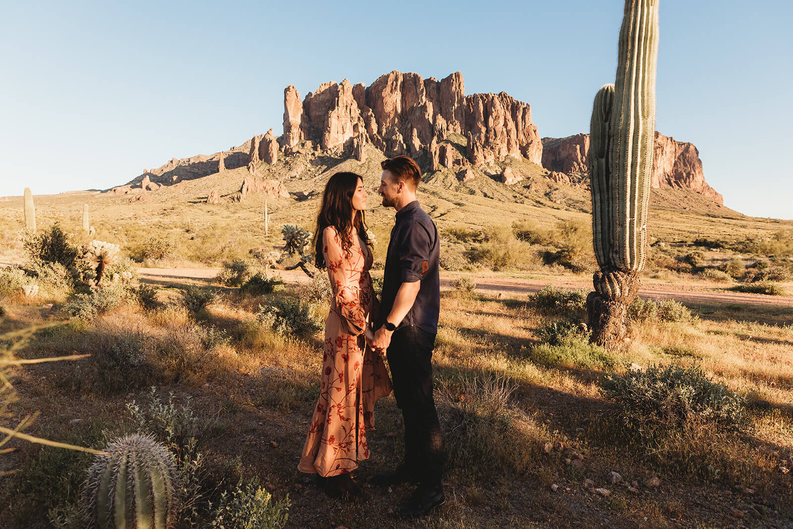  Couple hikes through desert wonderland during their engagement session in the Superstition Mountains outside of Phoenix, Arizona. Arizona engagament photographer 