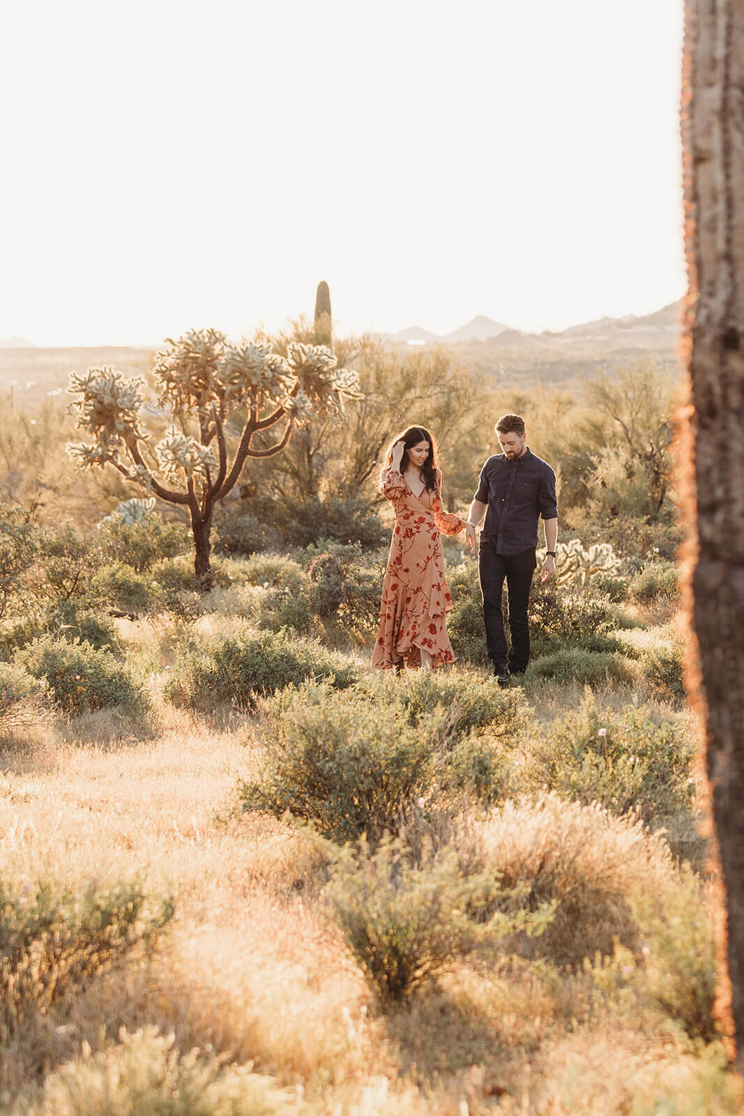  Couple hikes through desert wonderland during their engagement session in the Superstition Mountains outside of Phoenix, Arizona. Arizona engagament photographer 