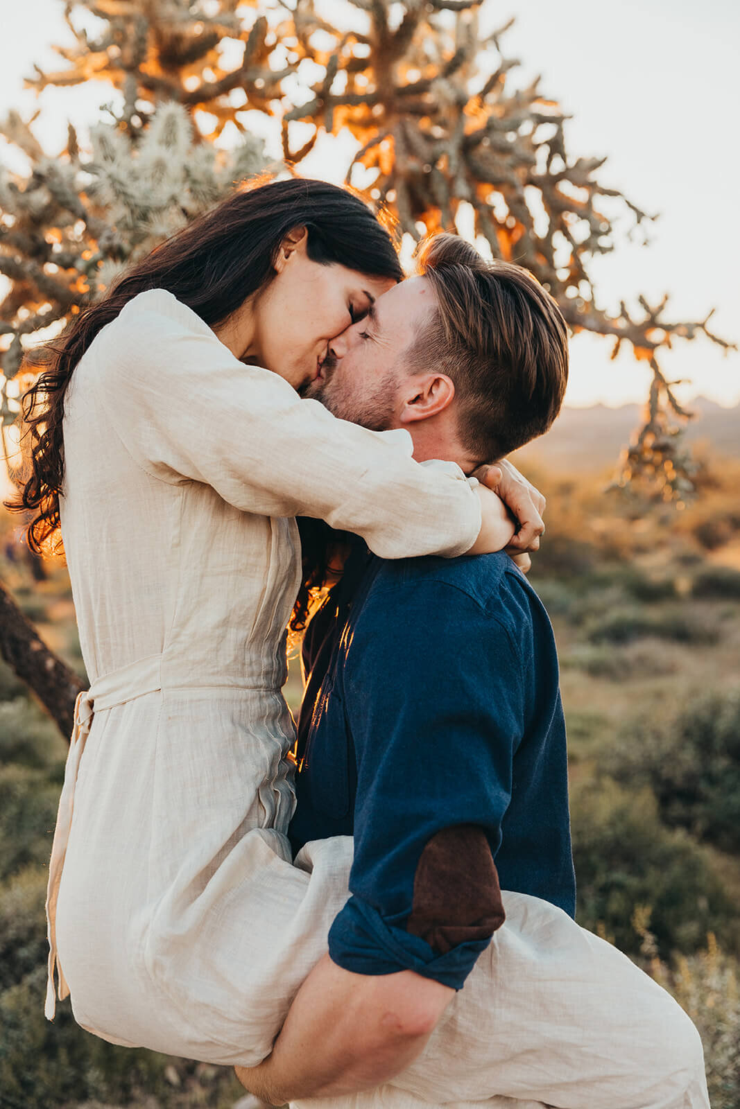  Couple hikes through desert wonderland during their engagement session in the Superstition Mountains outside of Phoenix, Arizona. Phoenix elopement photographer 