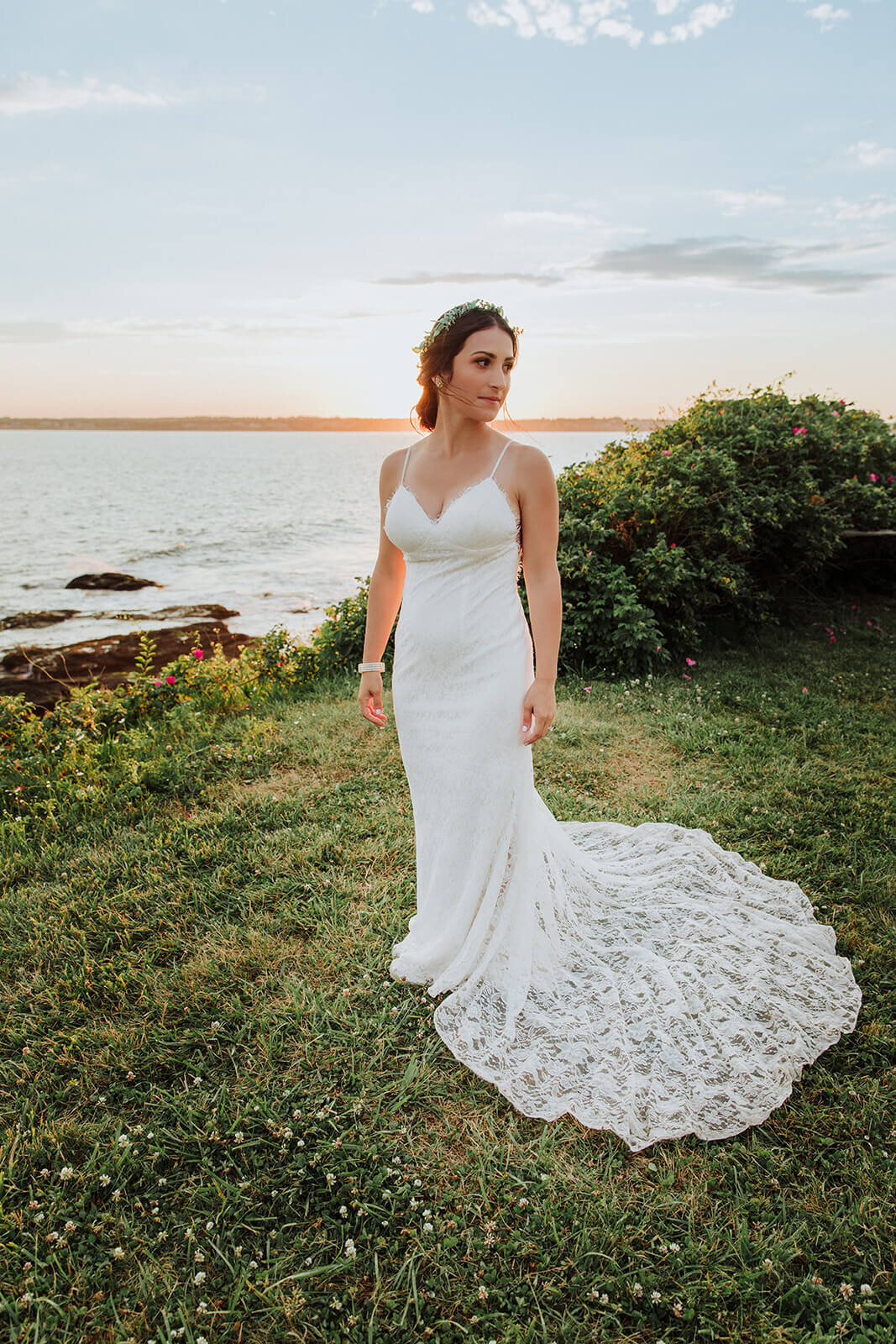  Bride during sunset at RI elopement. Couple elope at Beavertail Lighthouse in Rhode Island and involve their daughter in the day. 