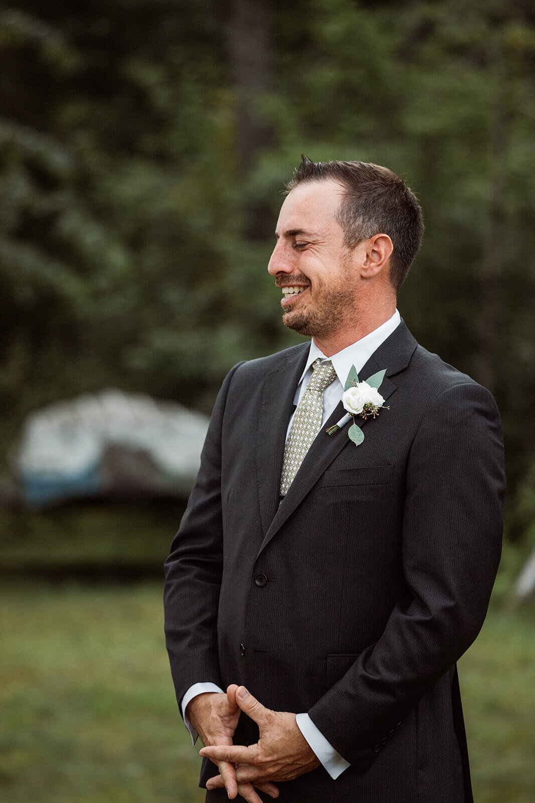  Groom reacts to seeing bride walk down the aisle. Small outdoor wedding in Maine. 