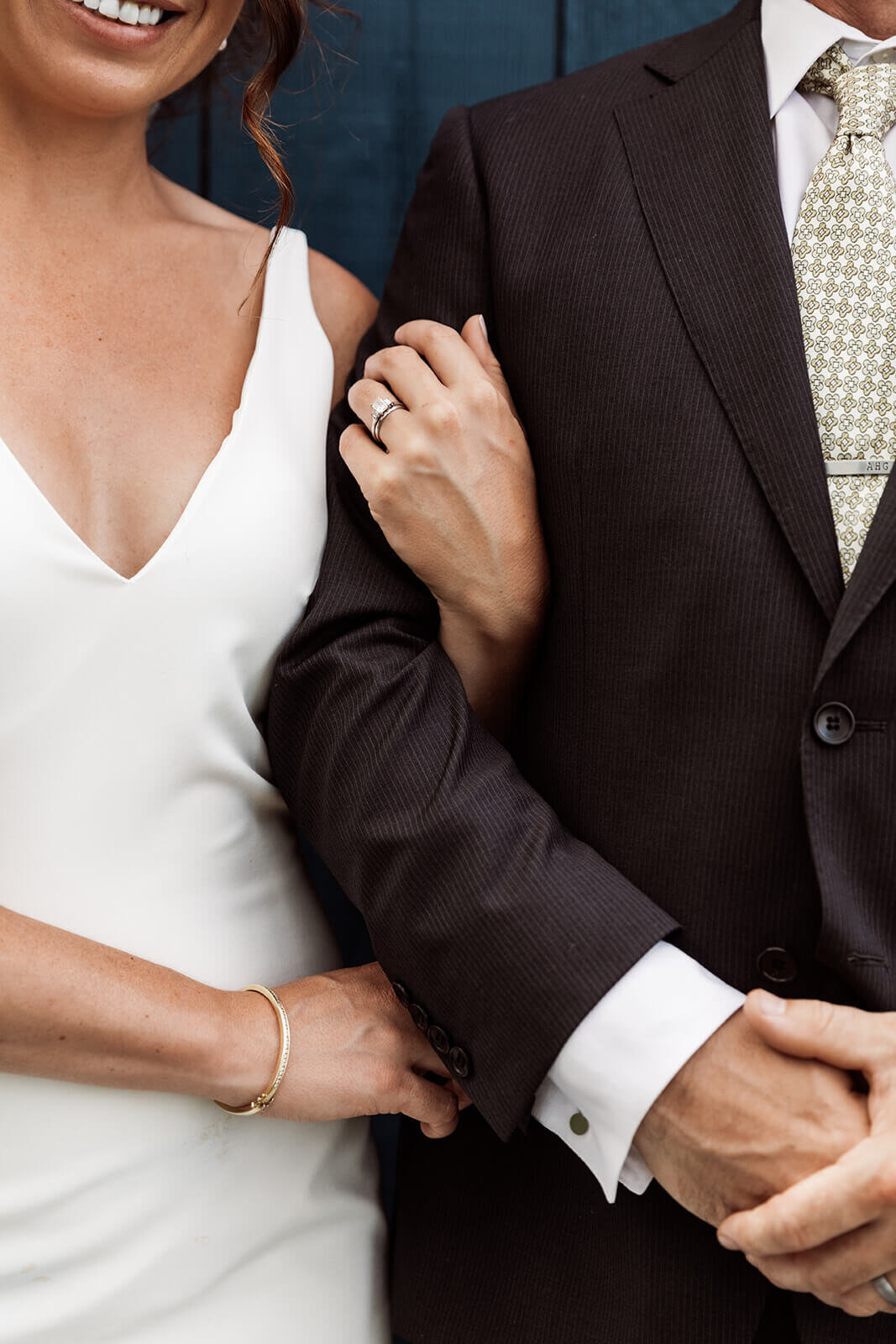  Close up of wedding rings. Newly married couple after their elopement with family in Maine. 