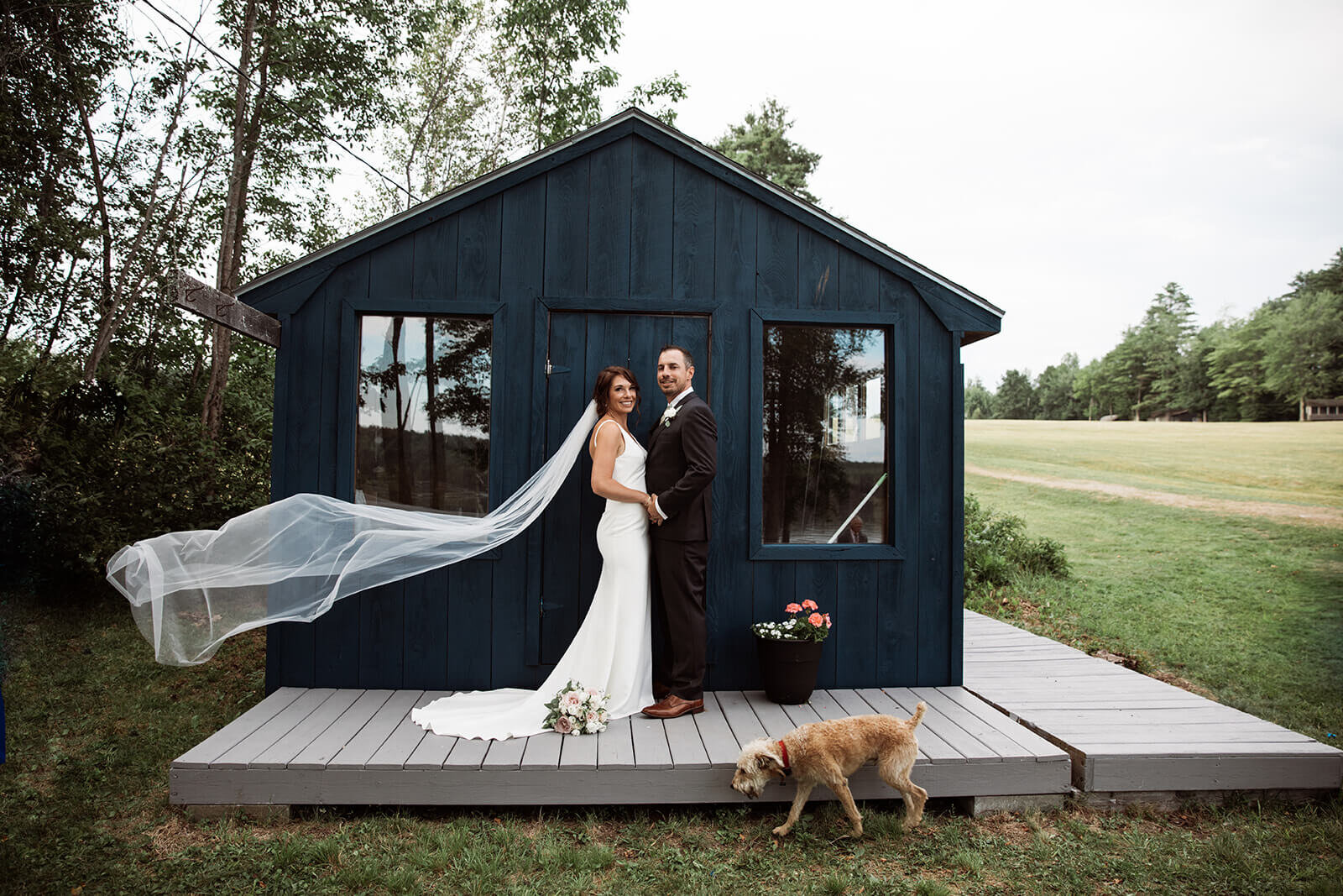  Happy married couple during their Maine elopement on a lake. 