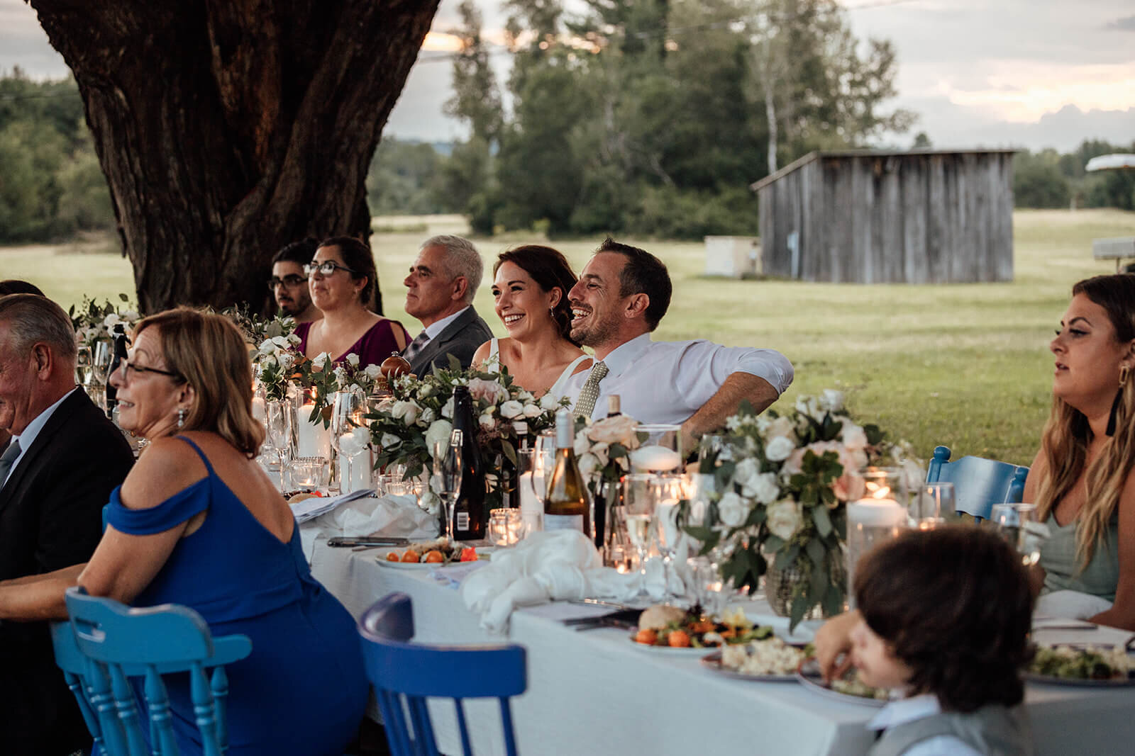  Couple reacts to speeches during their small outdoor wedding venue at Grace on the Lake in Maine. 