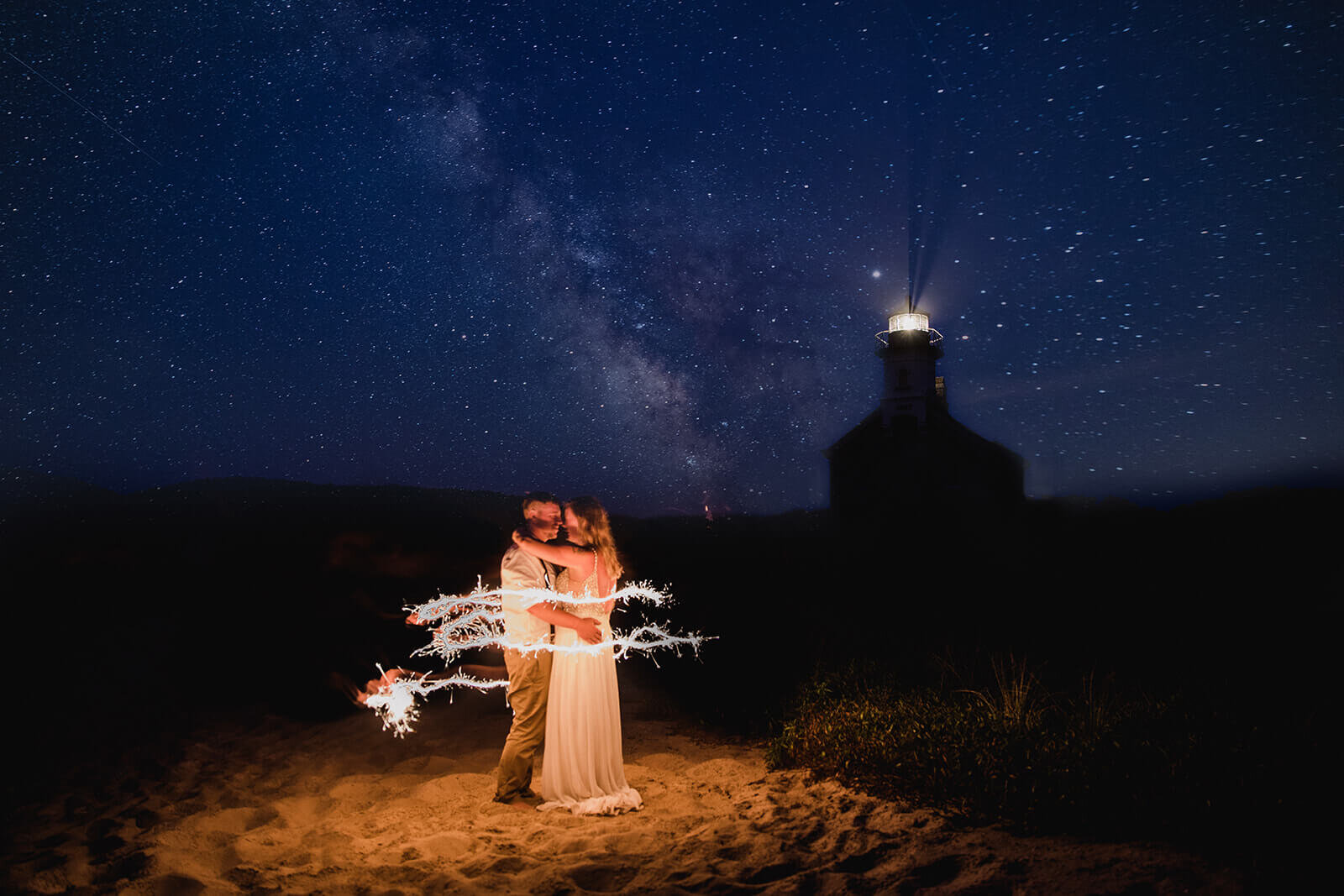  Eloping couple under the starry night sky at a lighthouse on Block Island off the coast of Rhode Island. 