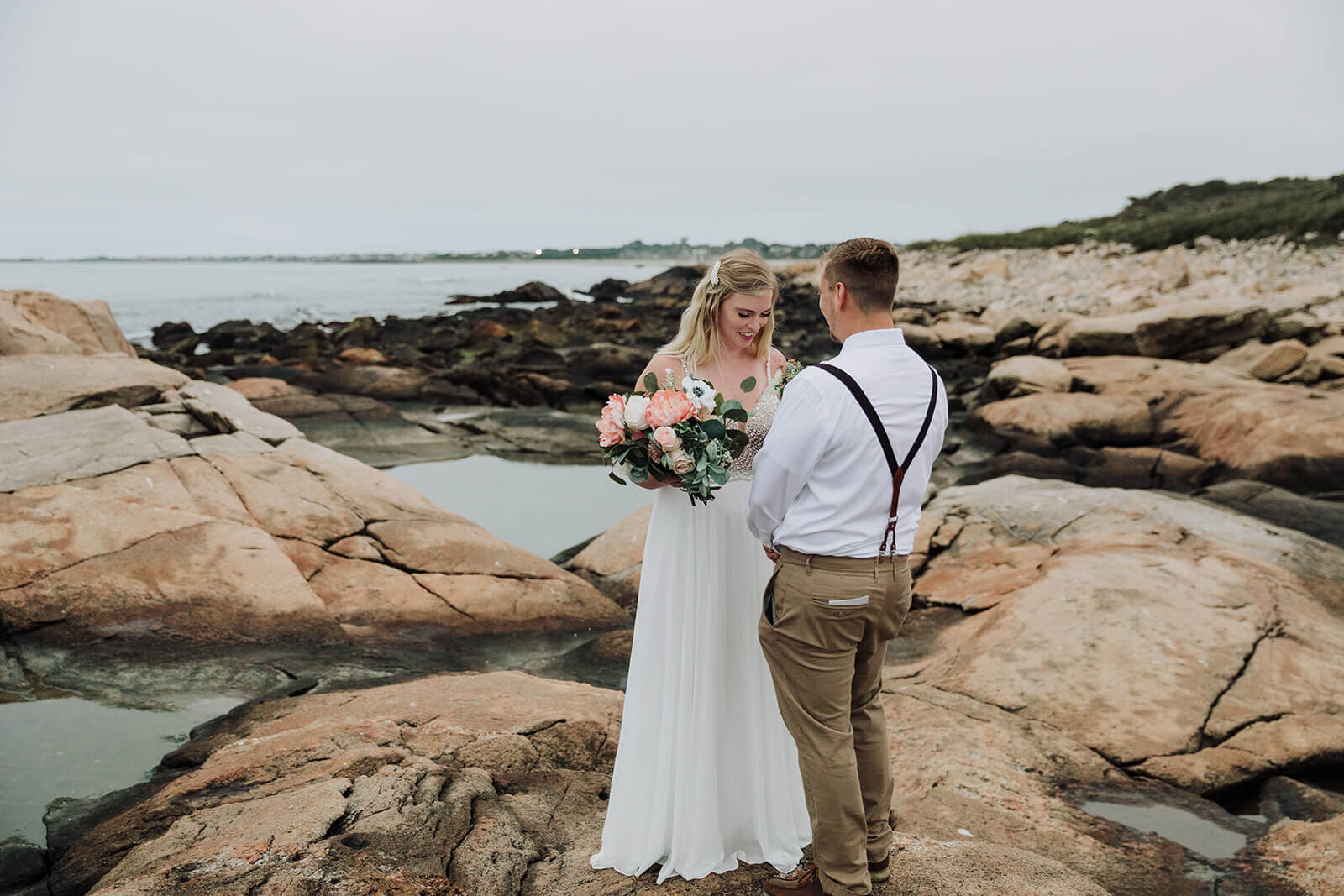  A couple reads vows during their elopement on the Rhode Island Coast in Narragansett. 