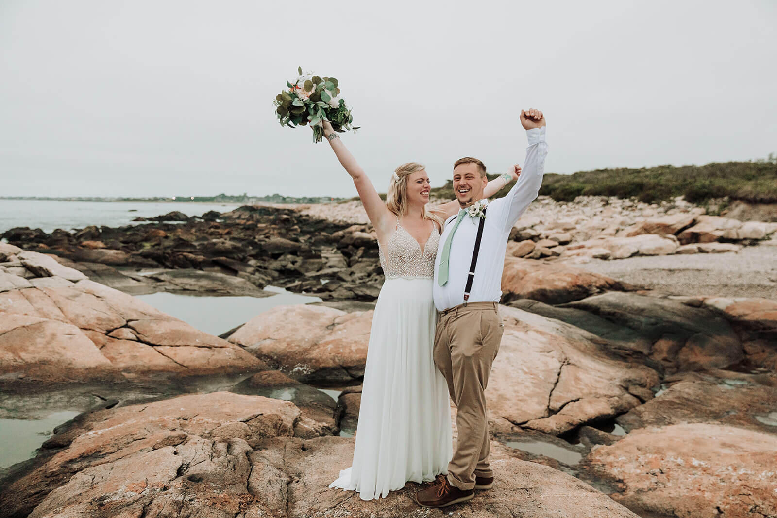  A couple celebrates during their elopement on the Rhode Island Coast in Narragansett. 