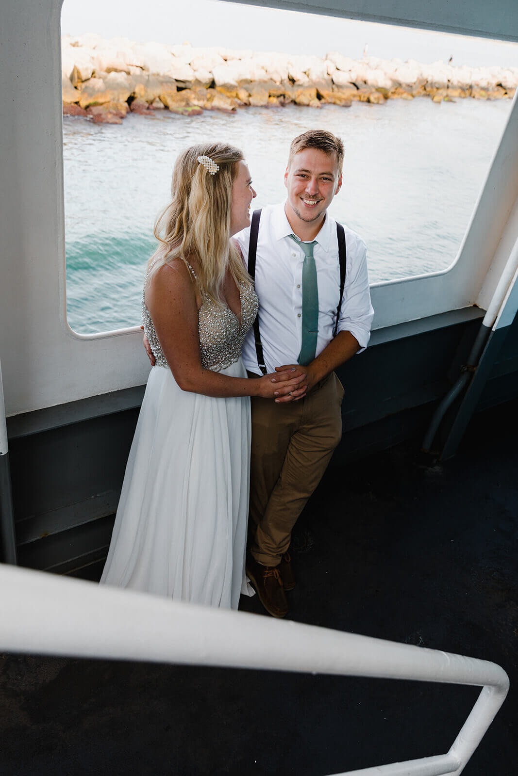  Couple looks out the ferry window on the way to Block Island while eloping in Rhode Island. 